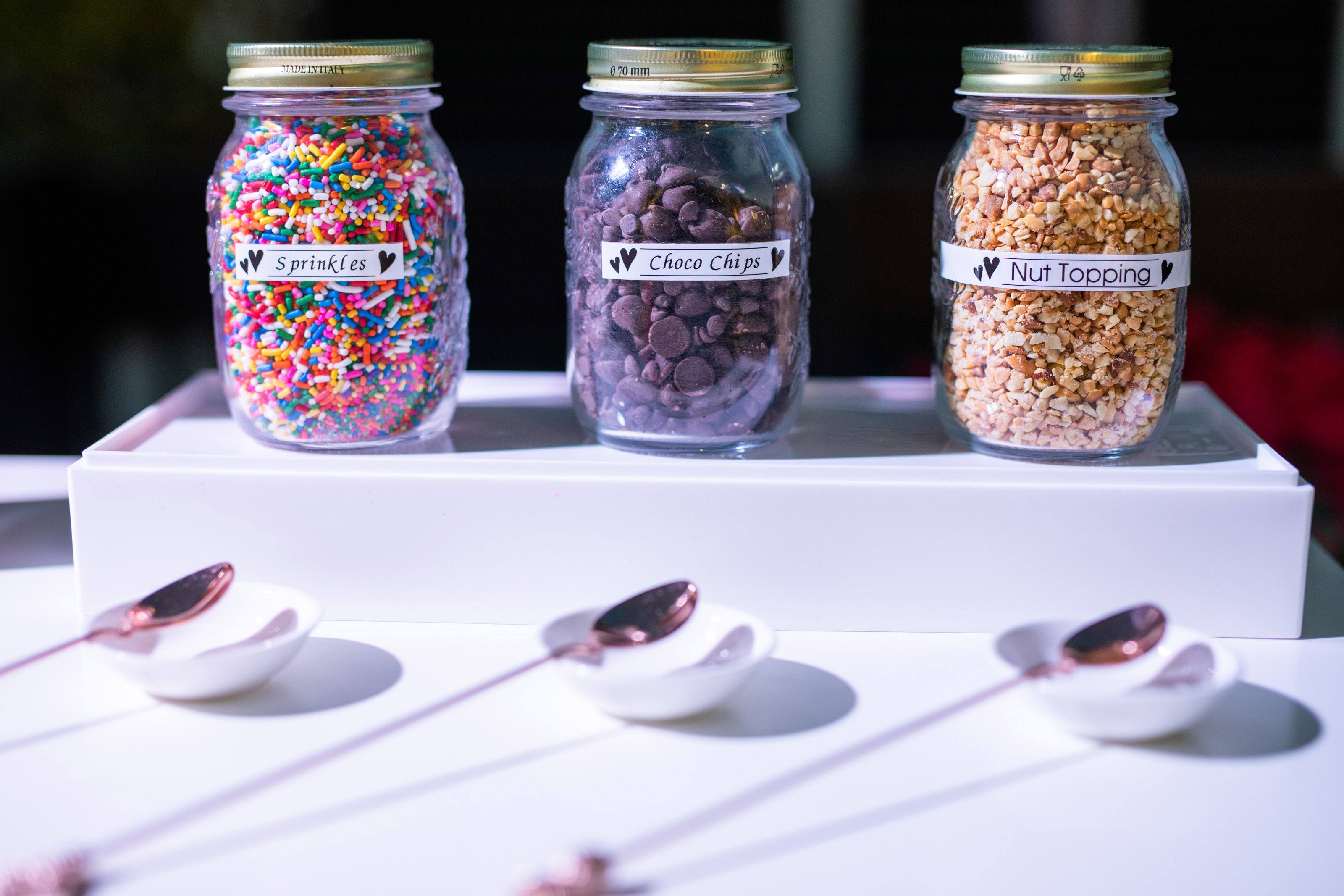 Mason jars filled with various ice cream toppings