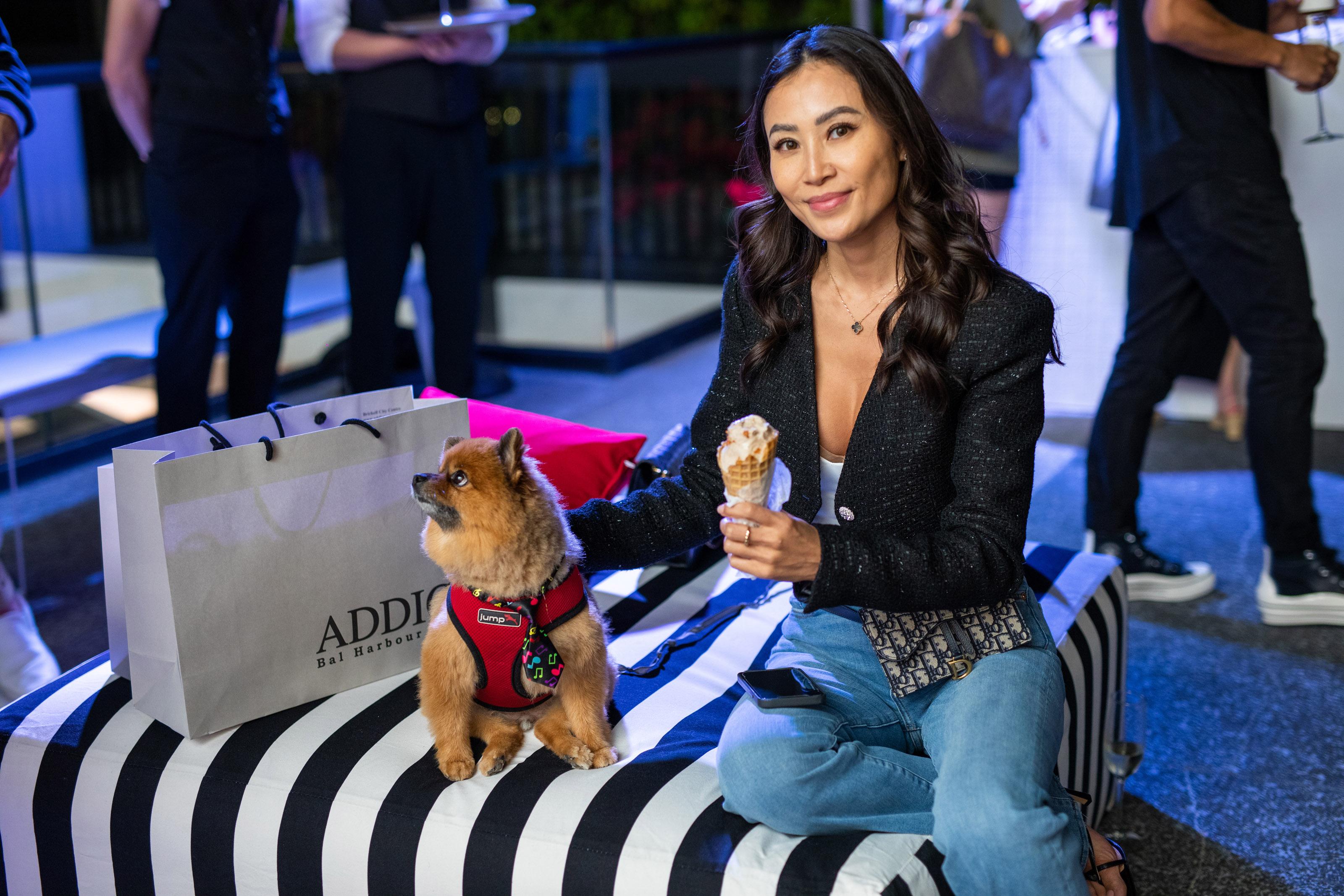 woman smiles next to a small dog