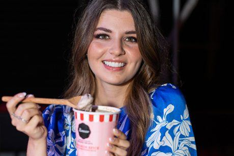 Valentina mussi smiles for a photo with a pint of ice cream