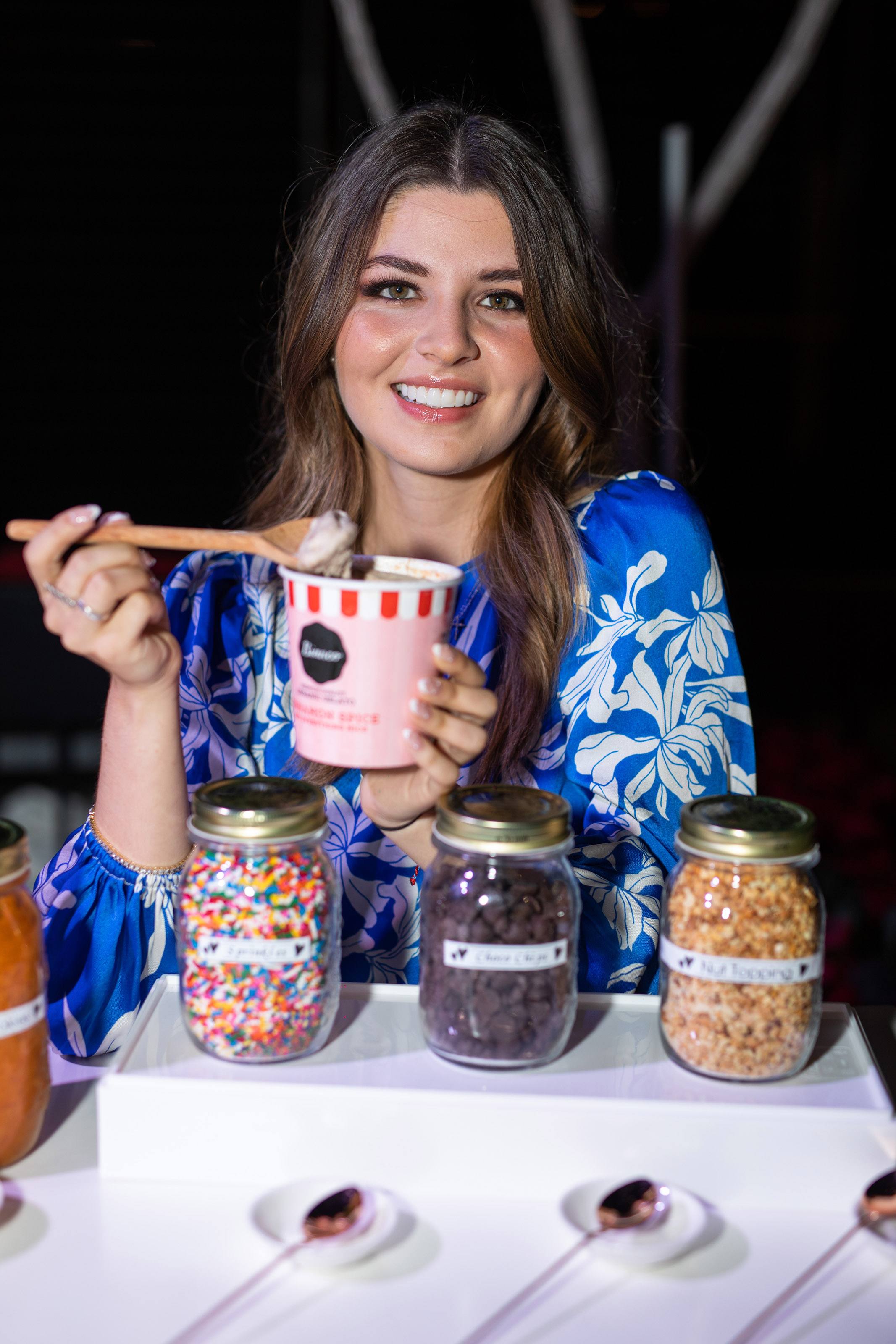 Valentina mussi smiles for a photo with a pint of ice cream