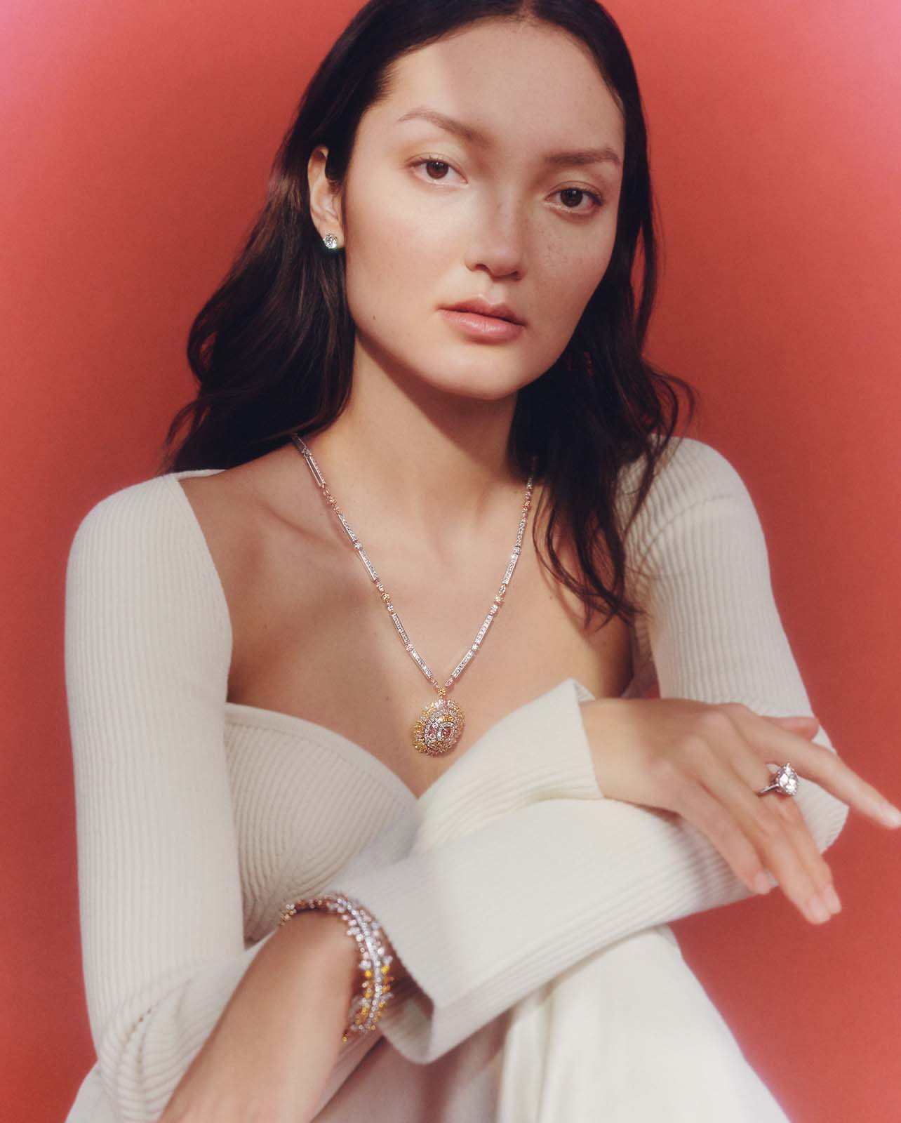 Woman posing with De Beers jewelry on