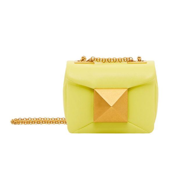 Mini lime green Valentino bag with large gold rock stud detail on the front