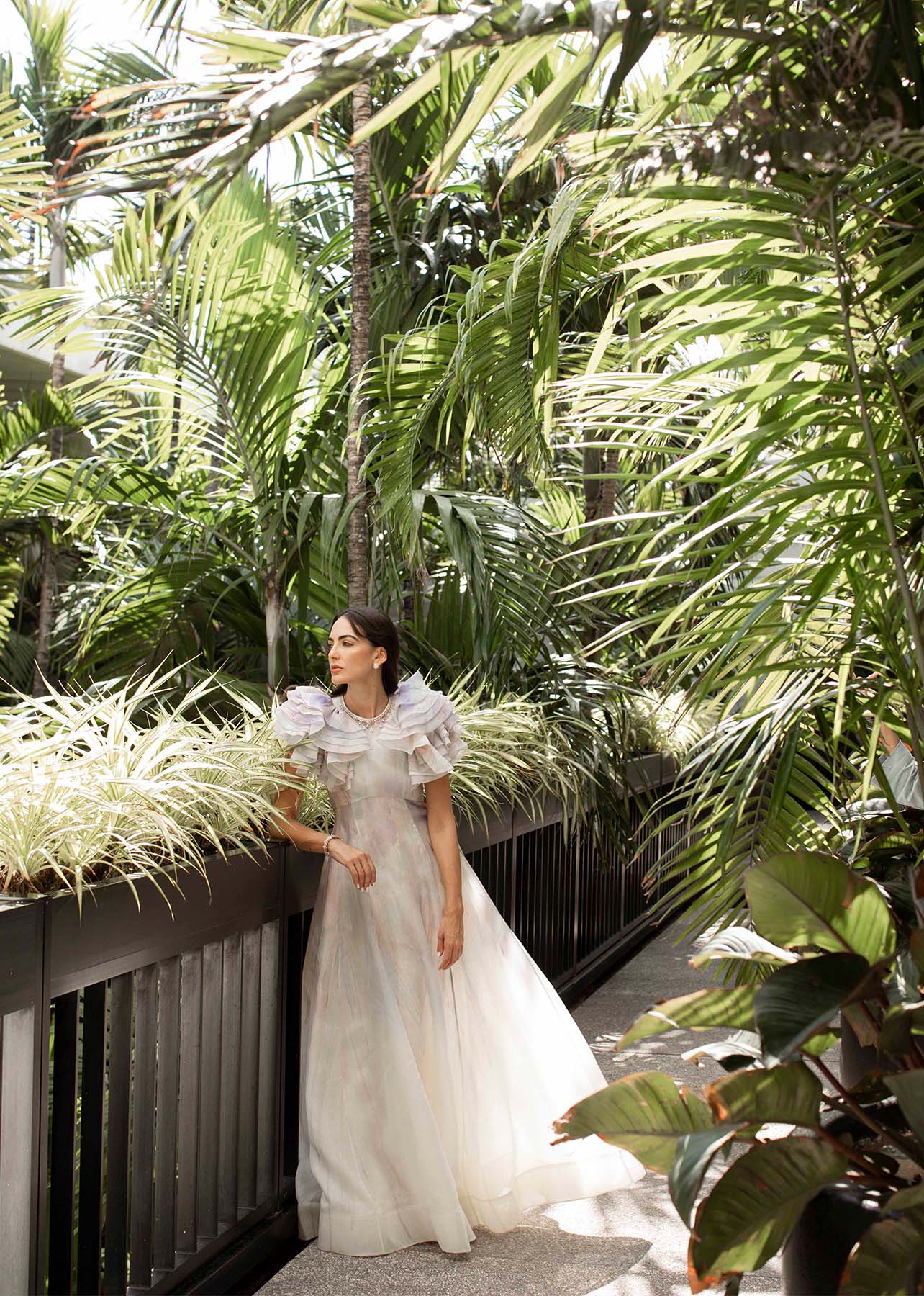 Shot of model in a floor length dress with ruffle sleeves