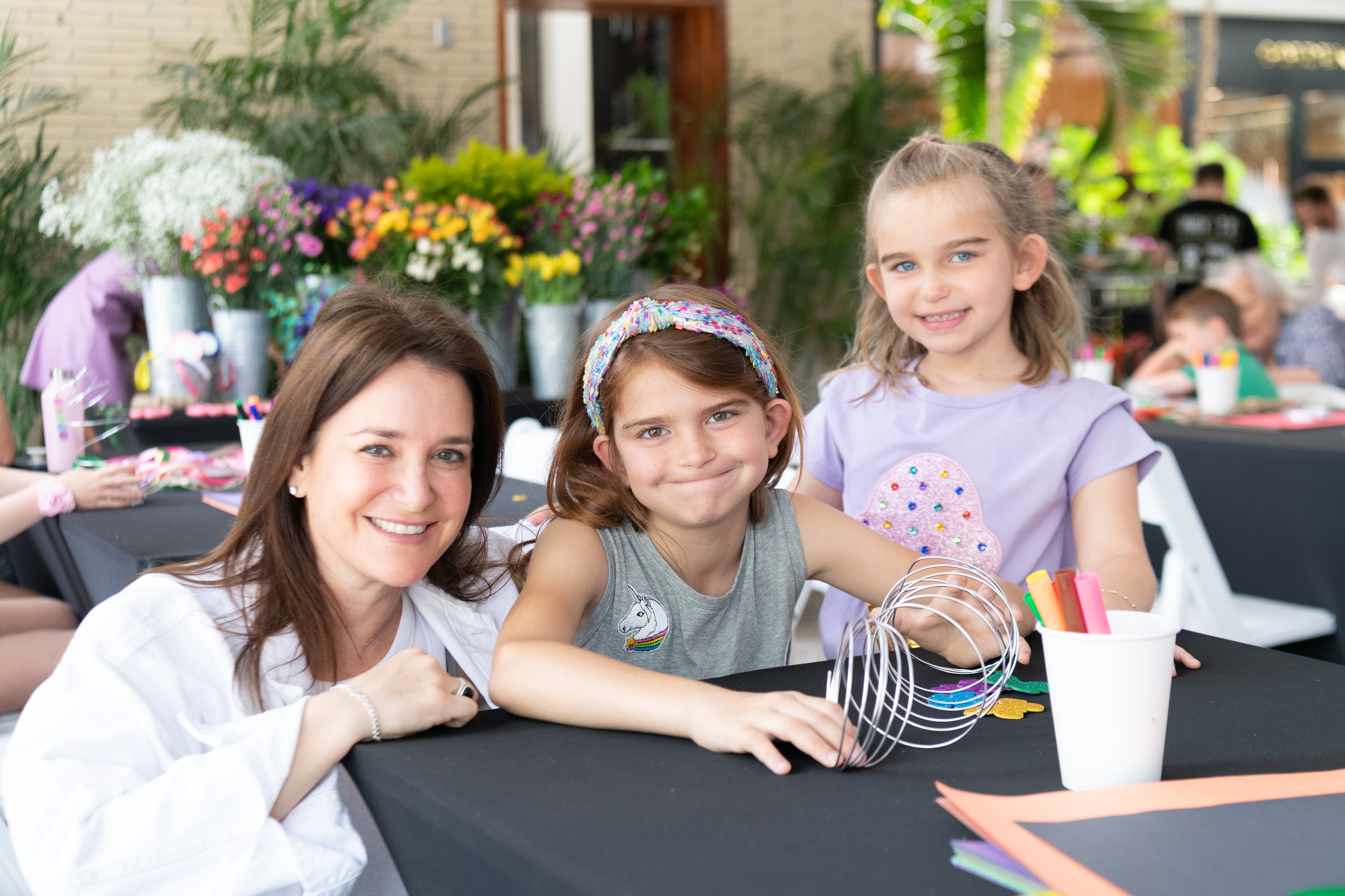 Mother smiles with her two daughters