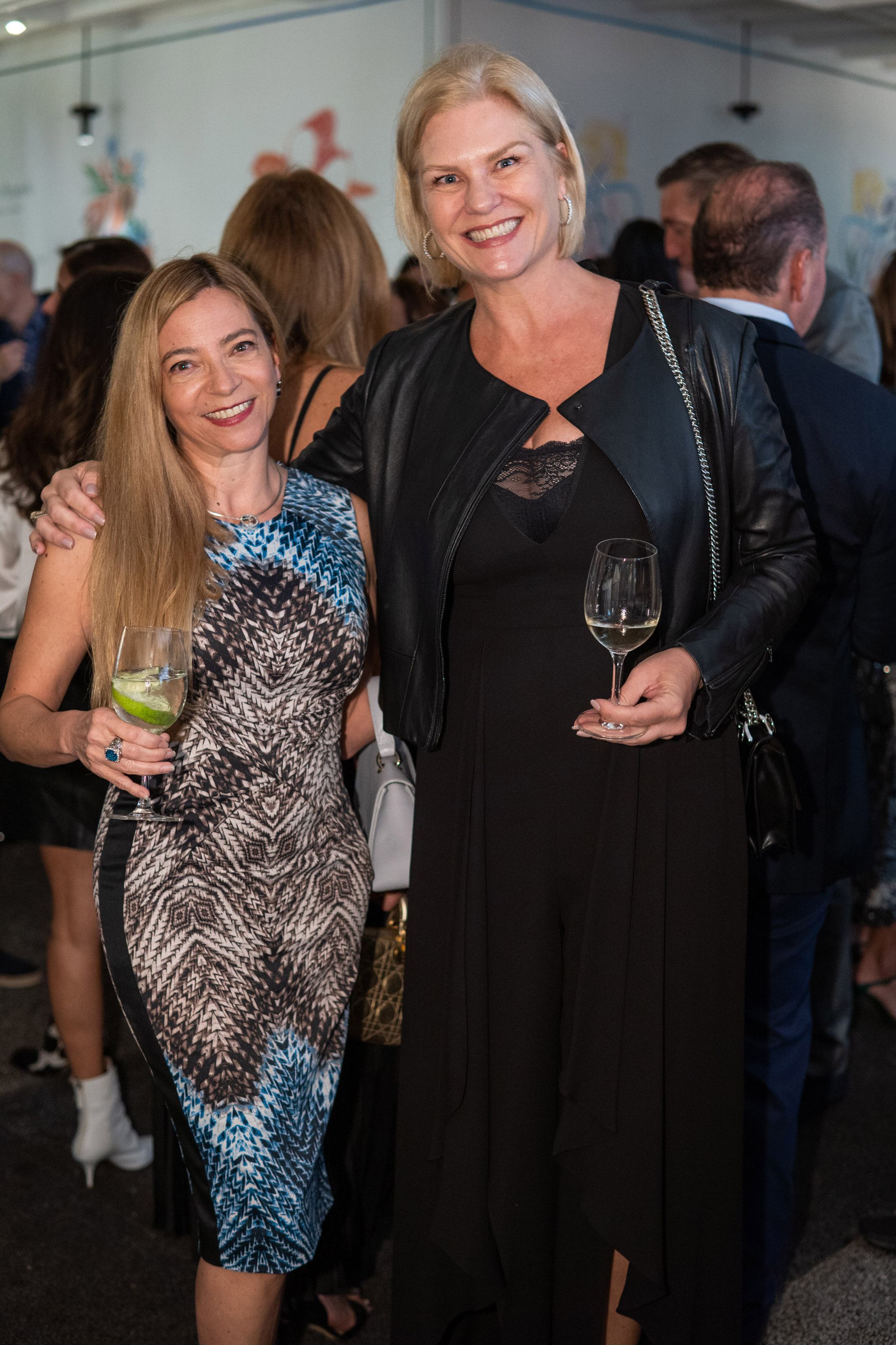 Two women smile for a photo together