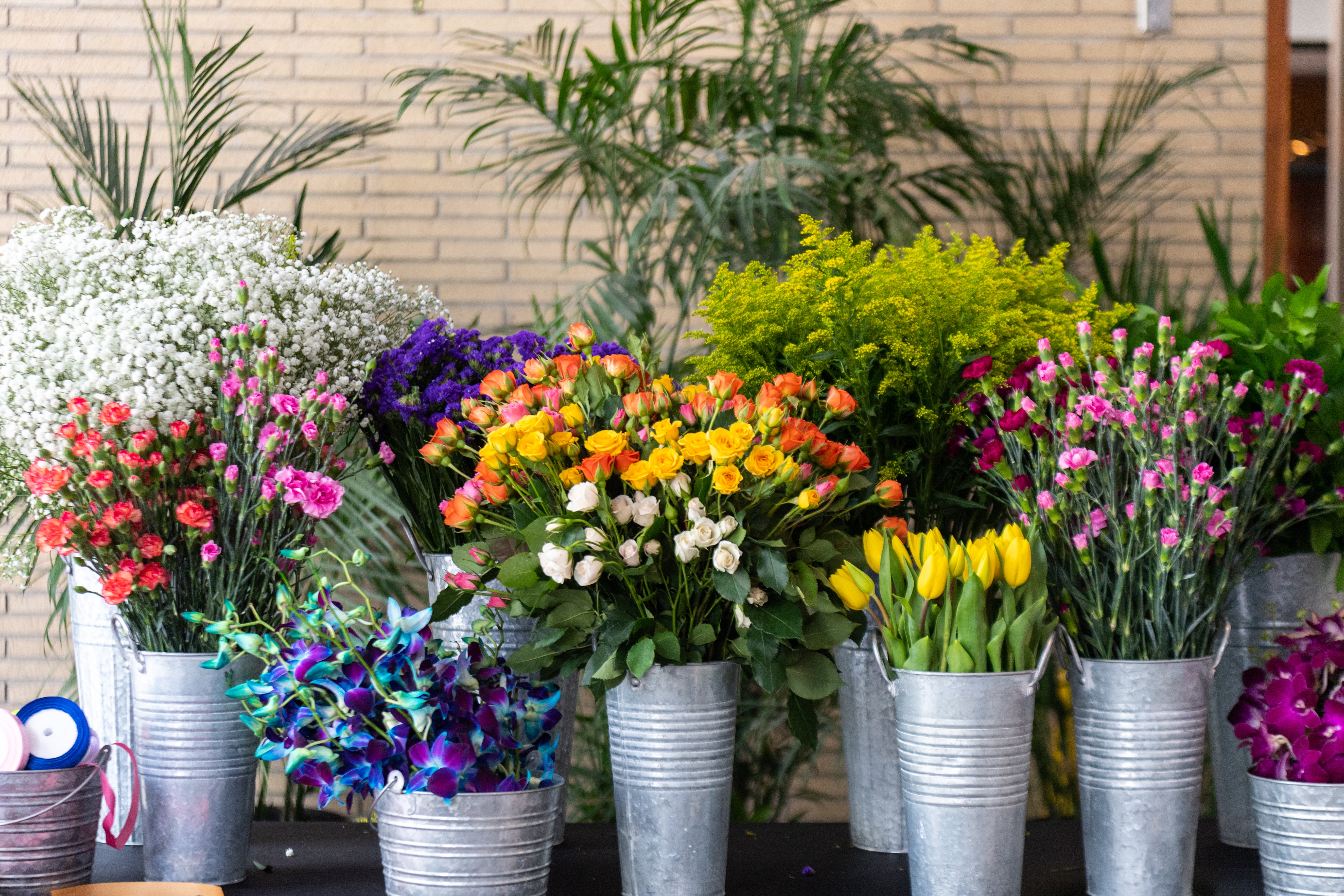 Assortment of colorful flowers in metallic cans