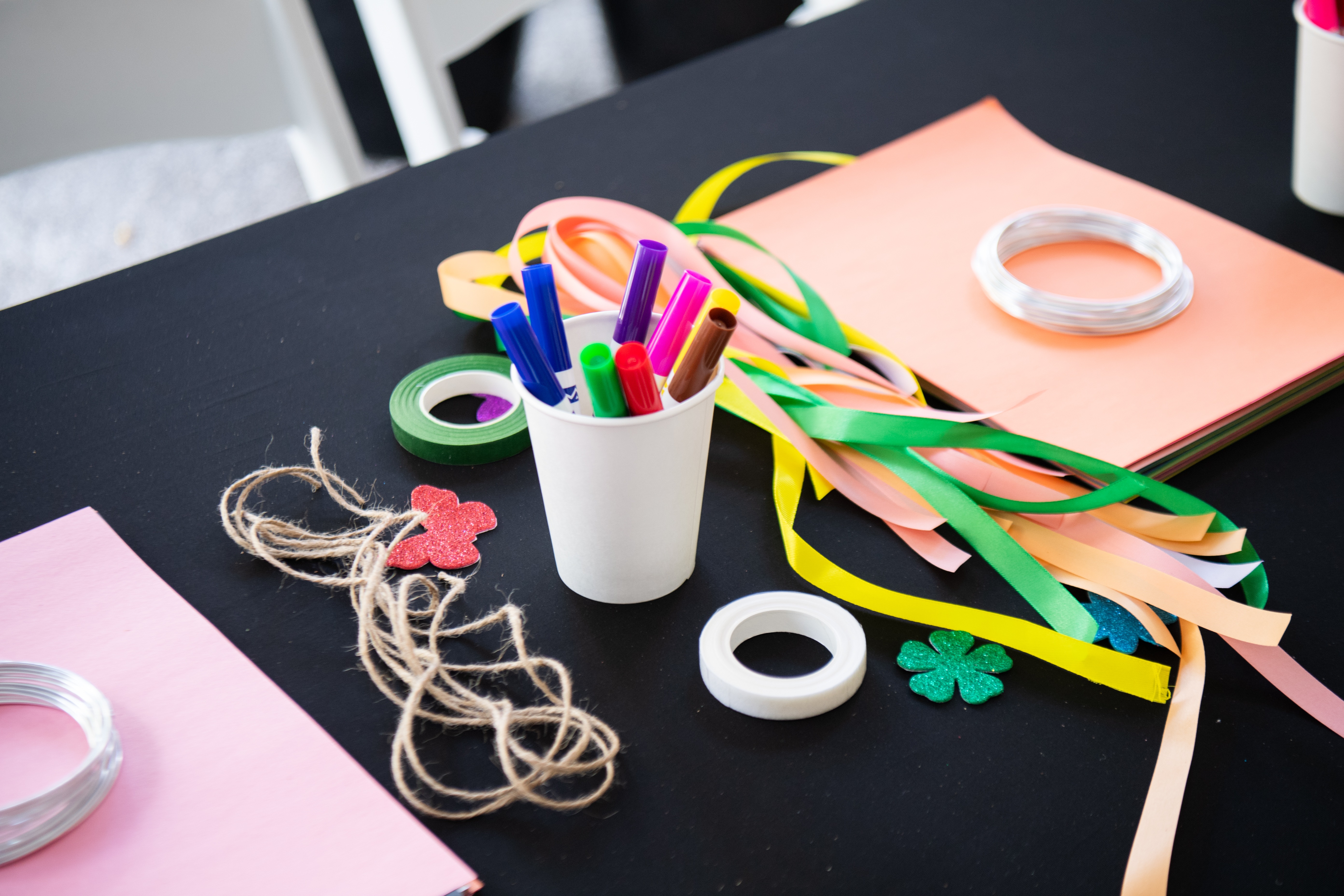 An assortment of craft supplies is strewn on a table