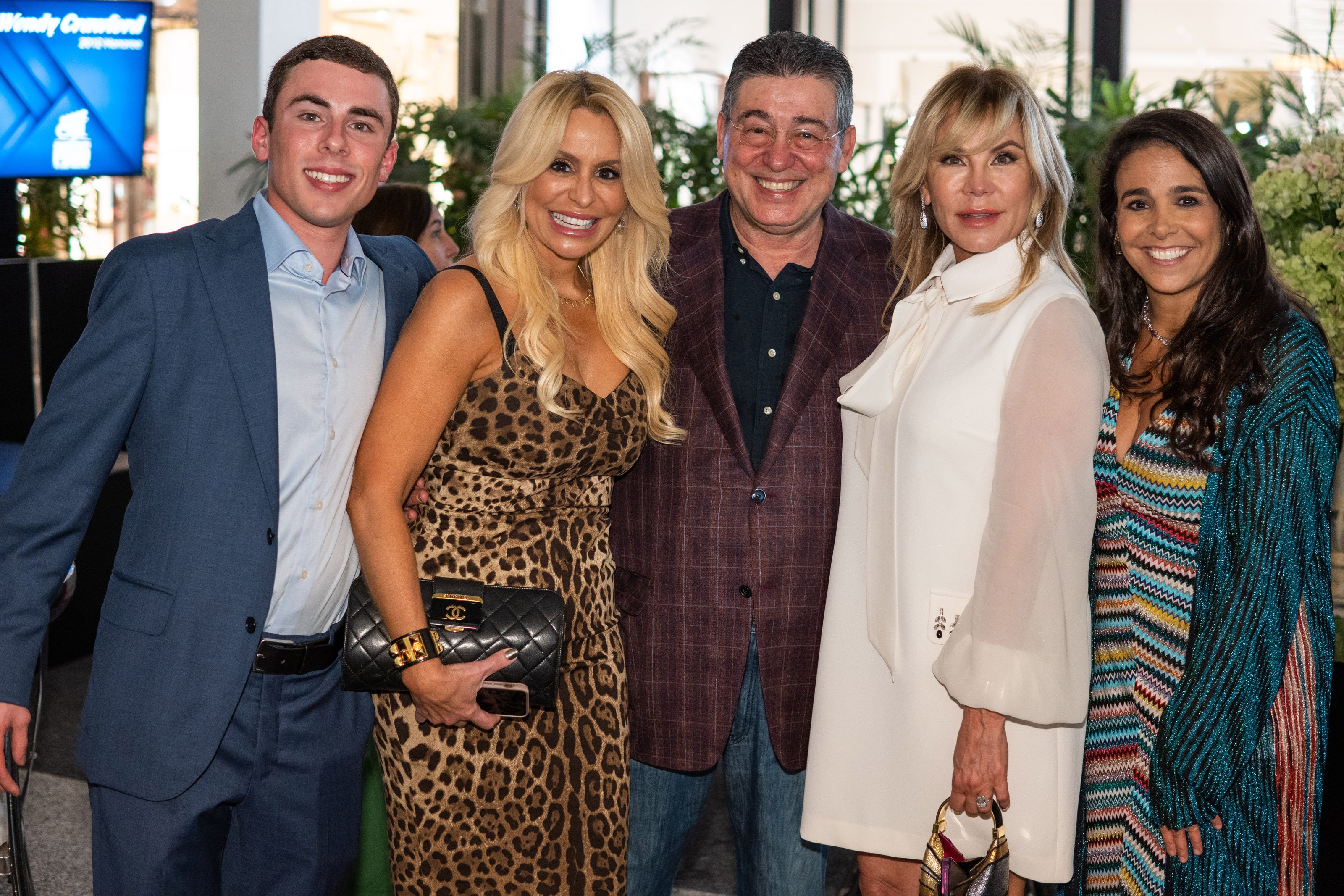 A group of party attendees smile for a photo together