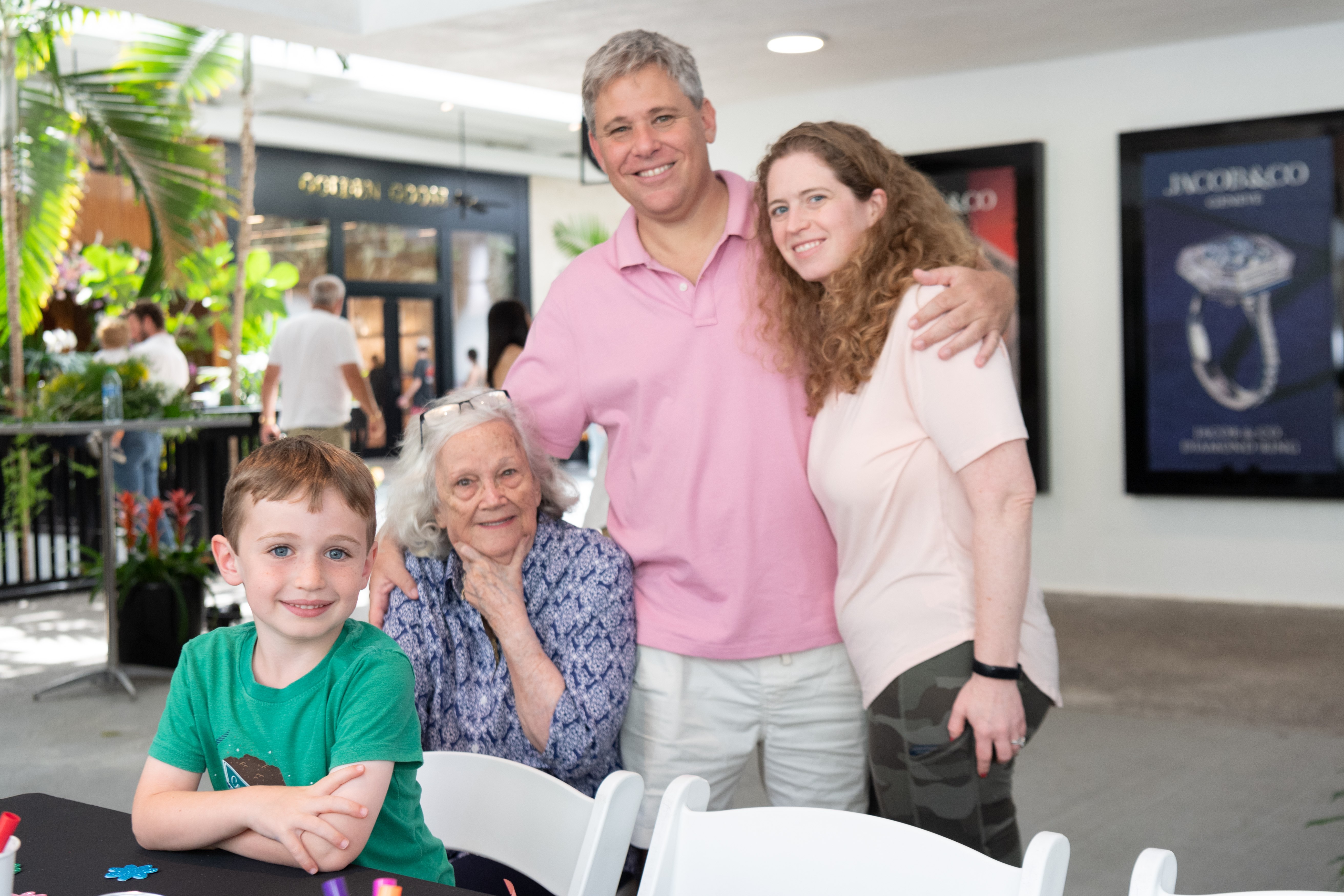 Father and mother smile for a photo with their two young children