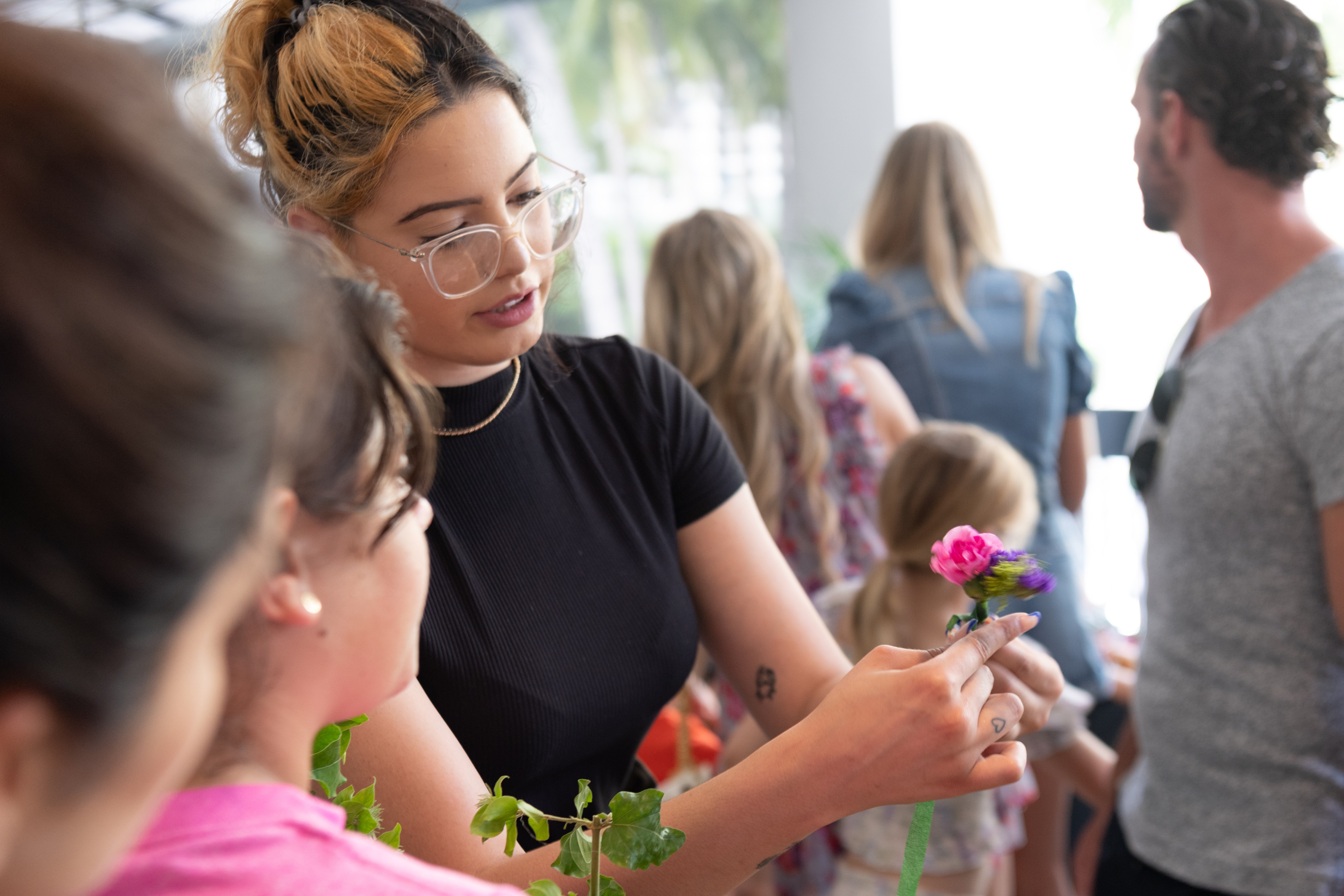 Woman demonstrating how to create a flower crown