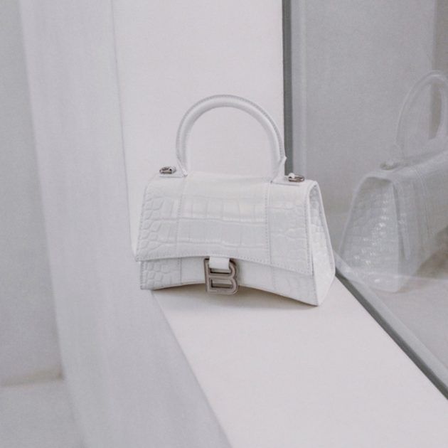 White handbag with top handle and silver “B” hardware