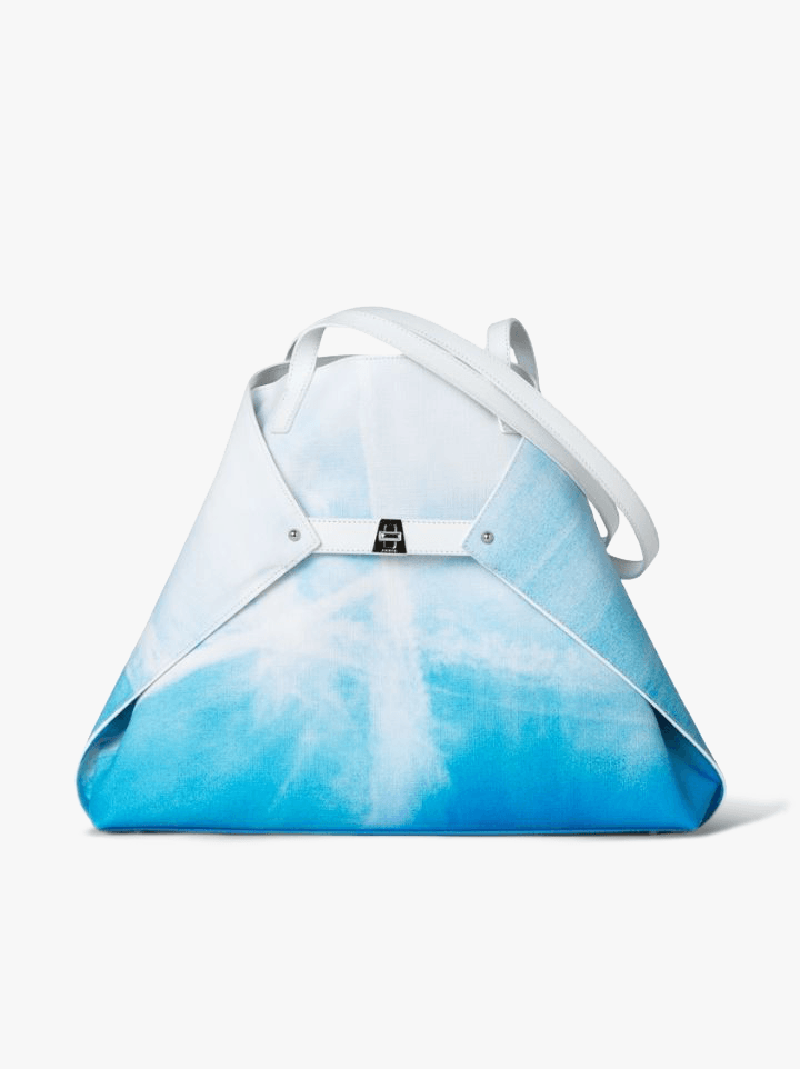 It’s light as a cloud, it folds, it can hold a snack pack and set of Hatchimals, but it never sacrifices style. Akris’s Medium Ai shoulder bag in St.Gallen Sky Print is an essential.
