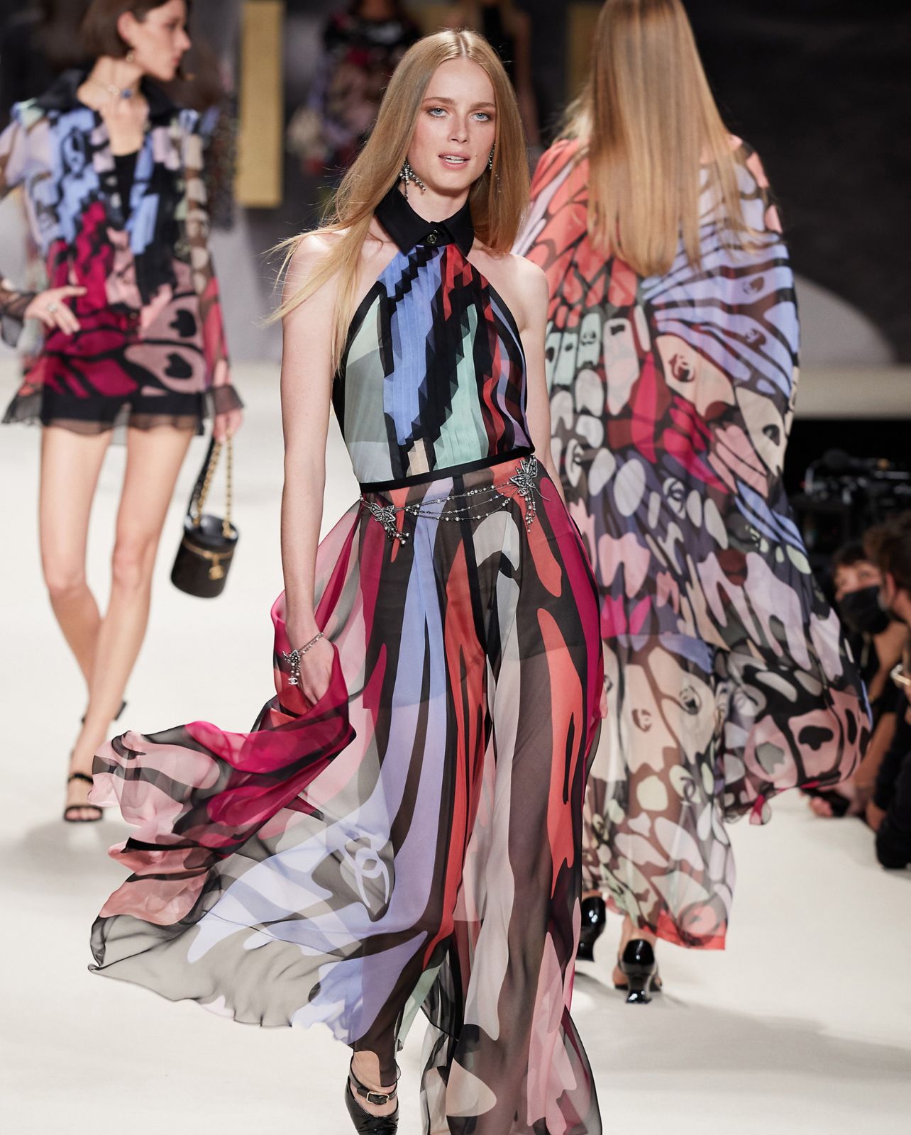 Chanel model walks runway in a multicolored halter dress