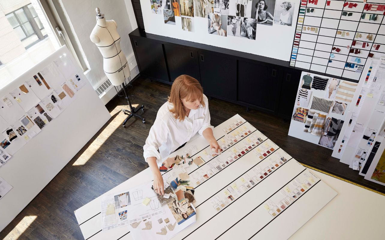 Woman views color swatches In a design studio setting