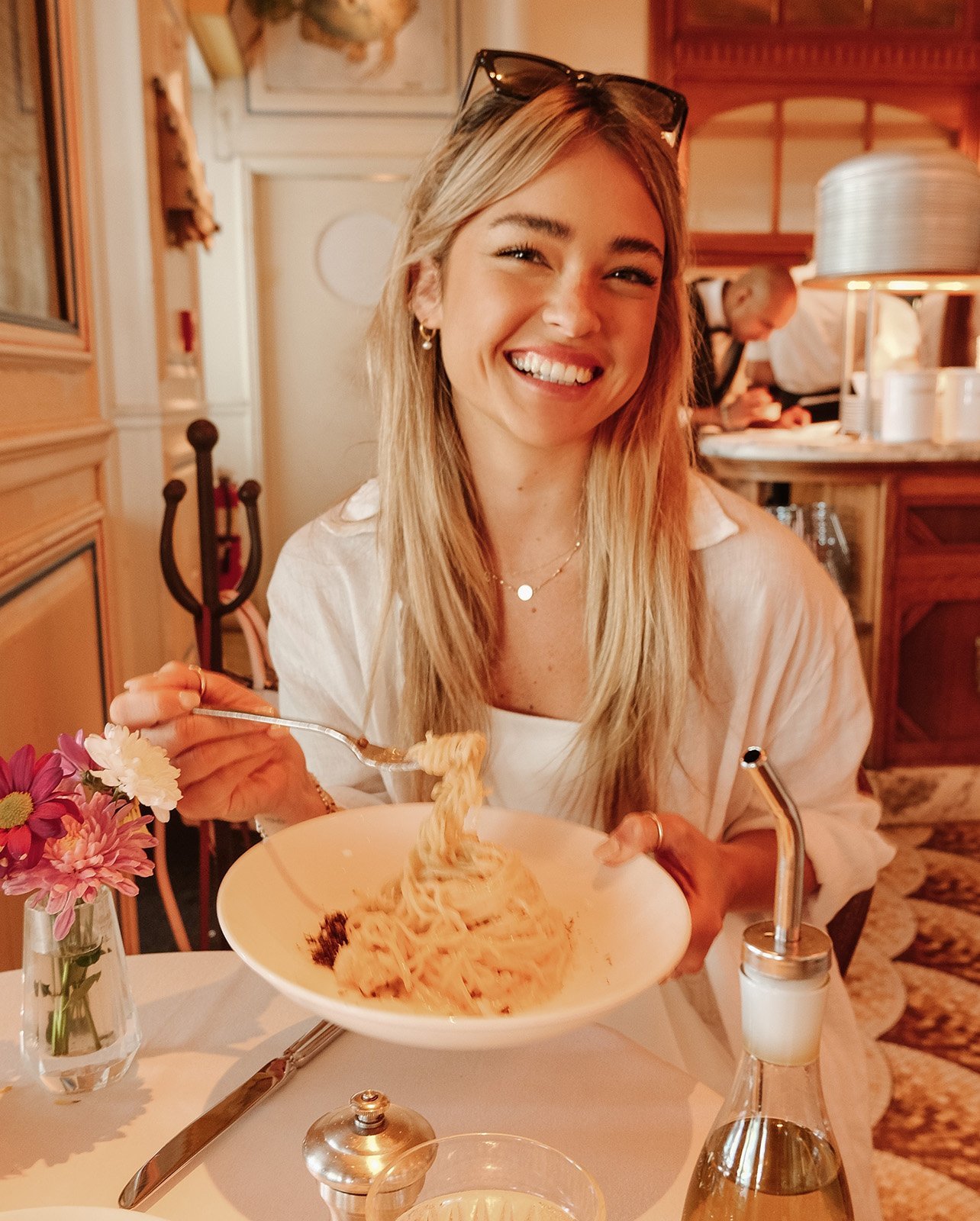 Portrait of Vale Genta smiling with a bowl of pasta from Le Zoo