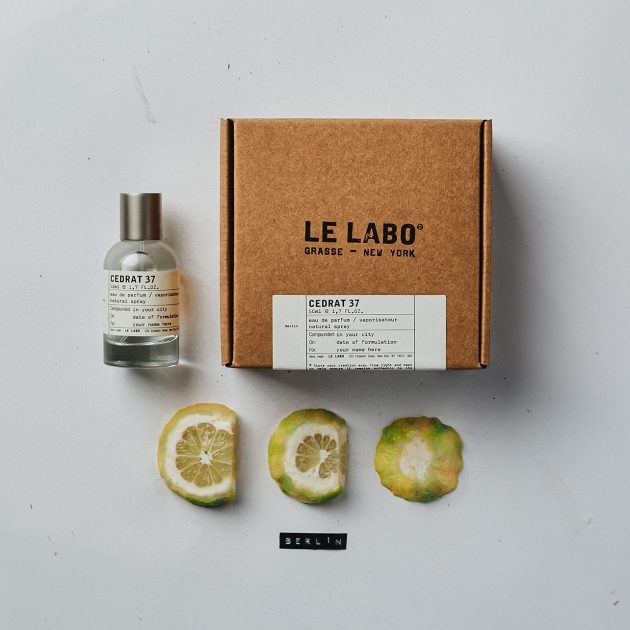Le Labo Cedrat fragrance bottle staged with a sliced lime