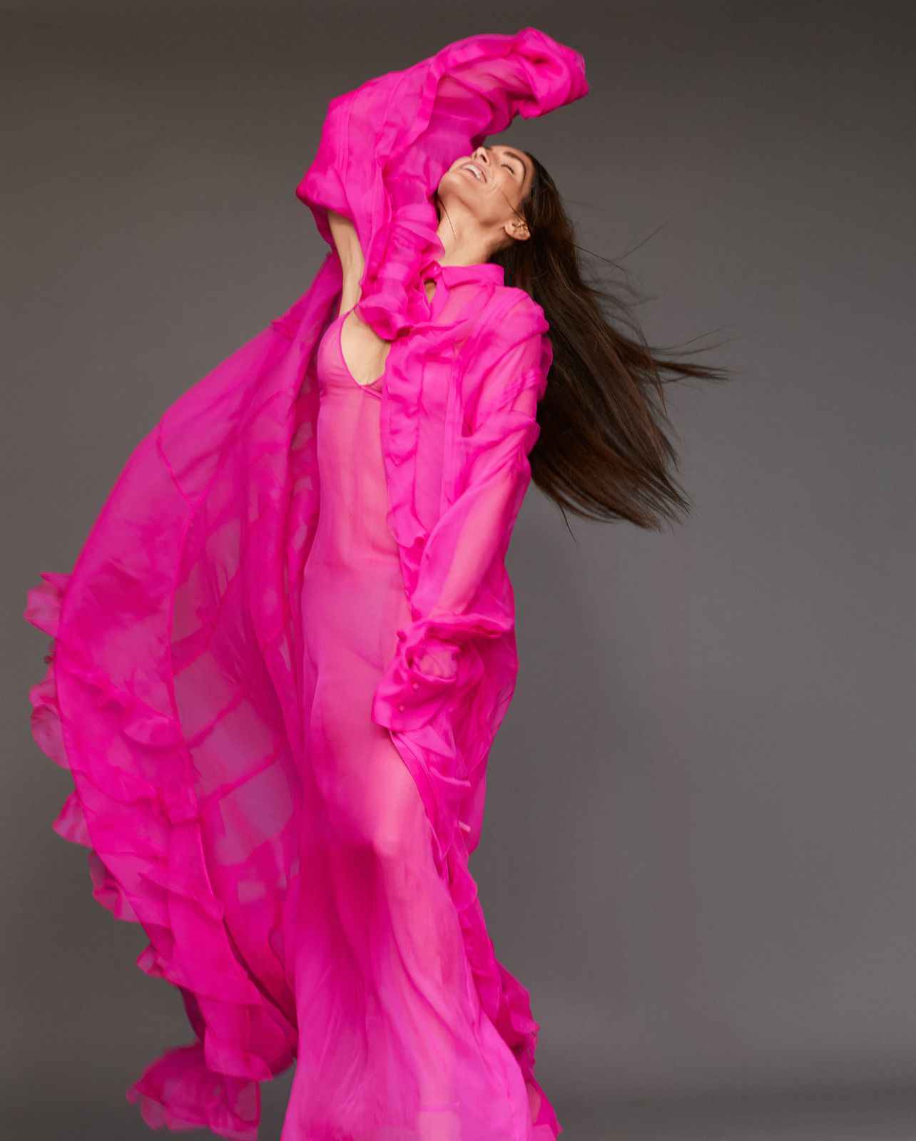 Model poses in a pink valentino dress