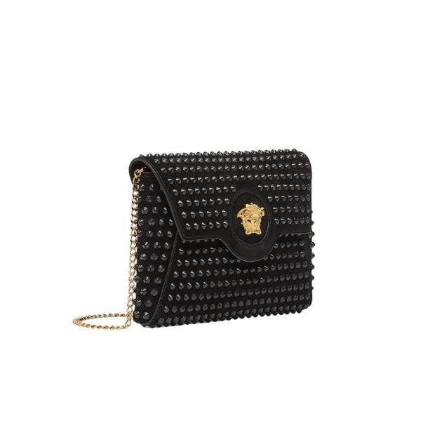 Black studded bag with medusa head closure and shoulder strap