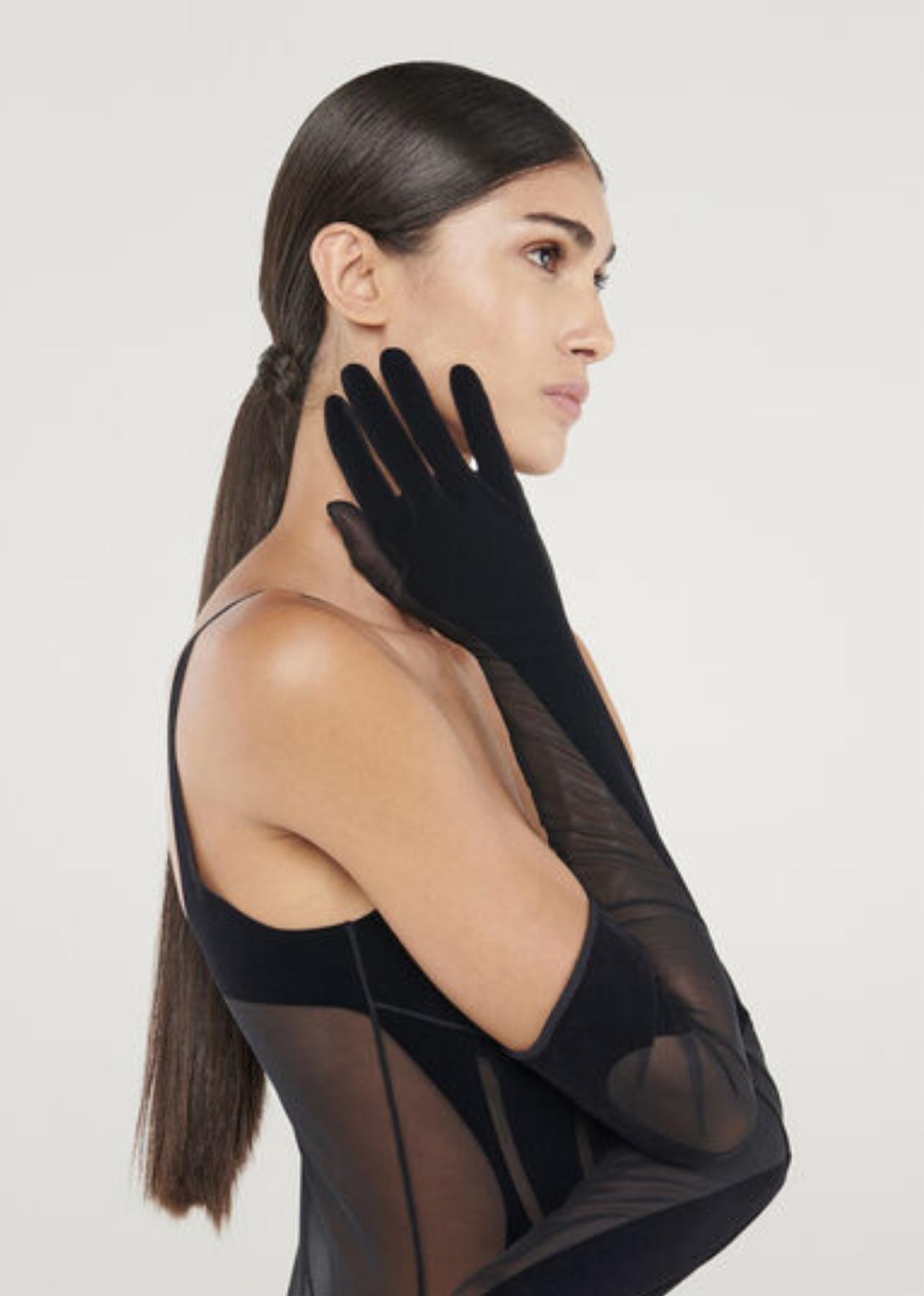 Model wearing long, black Mugler by Wolford gloves
