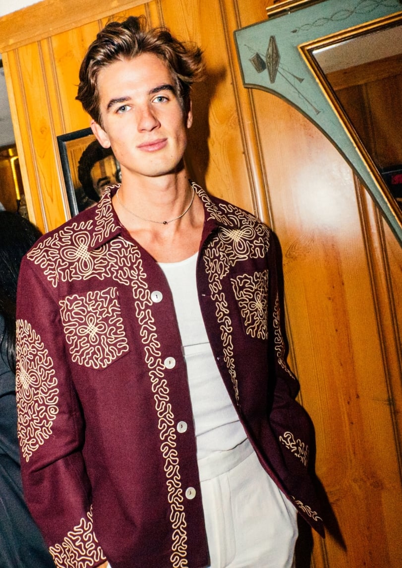 Image of Harrison Vail in a burgundy button down with cream-colored embroidery