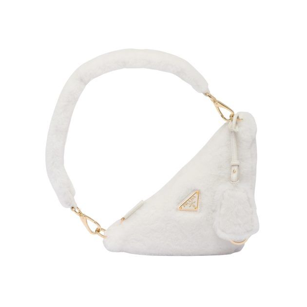 Portrait of white shearling triangular mini bag with gold hardware