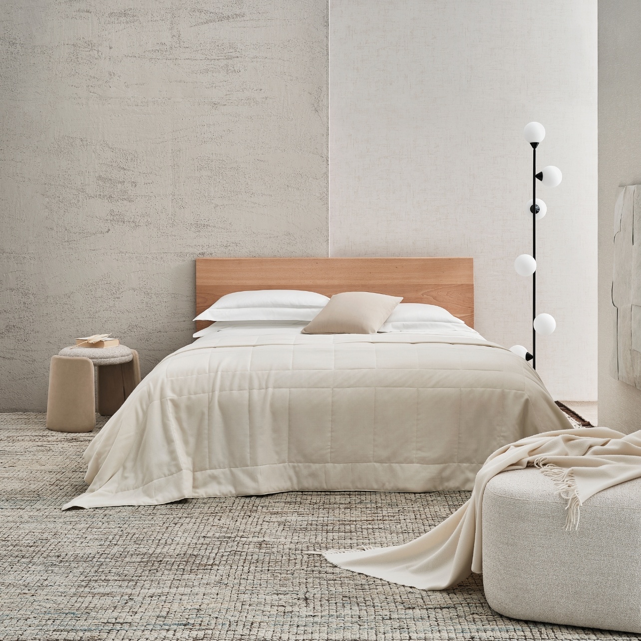 Image showcasing Frette bed linens and pillows in neutral tones