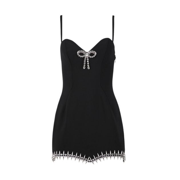 Portrait of black mini dress with silver spike and rhinestone embellishments