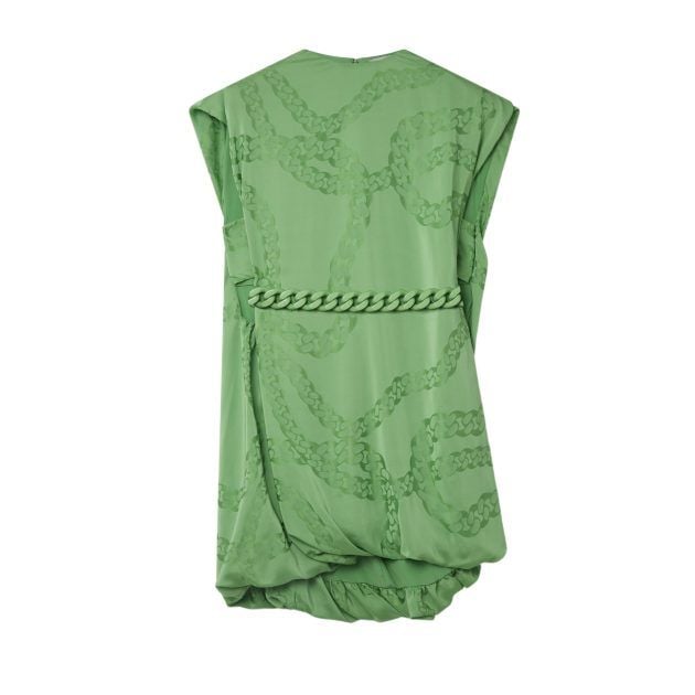 Portrait of green silk mini dress with tinal chain print and chain belt