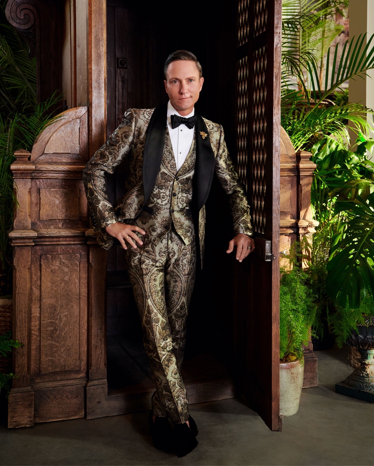 Portrait of Ken Fulk wearing a black and gold suit photographed by Brendan Mainini