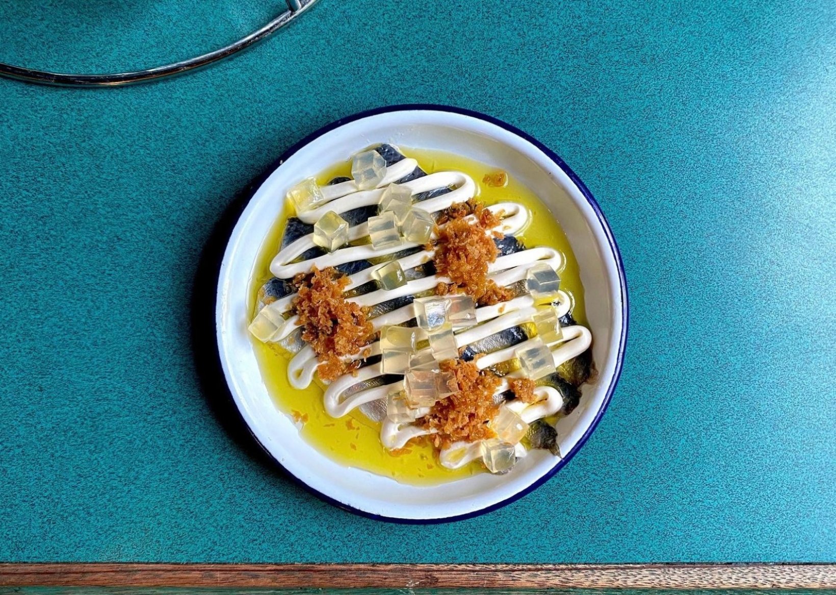 A dish of marinated sardines, mezcal jelly and sour cream at Clamato