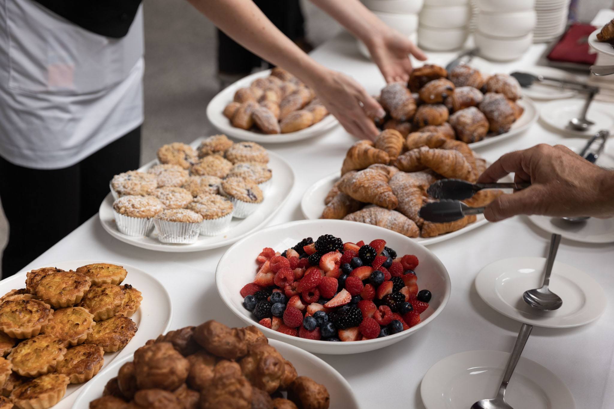 A variety of images showcasing the event with Raymond Jungles. Images include guests in attendance, event décor, and brunch bites provided by Le Zoo.