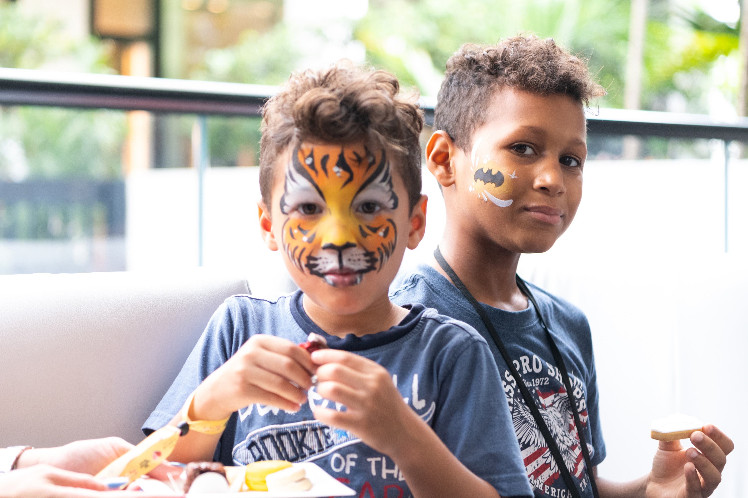 A variety of images showcasing the fourth annual “Ice Cream We Love” event. Images include guests in attendance, ice cream treats and setup, and activities featured at the event including games, face painting, and performances.