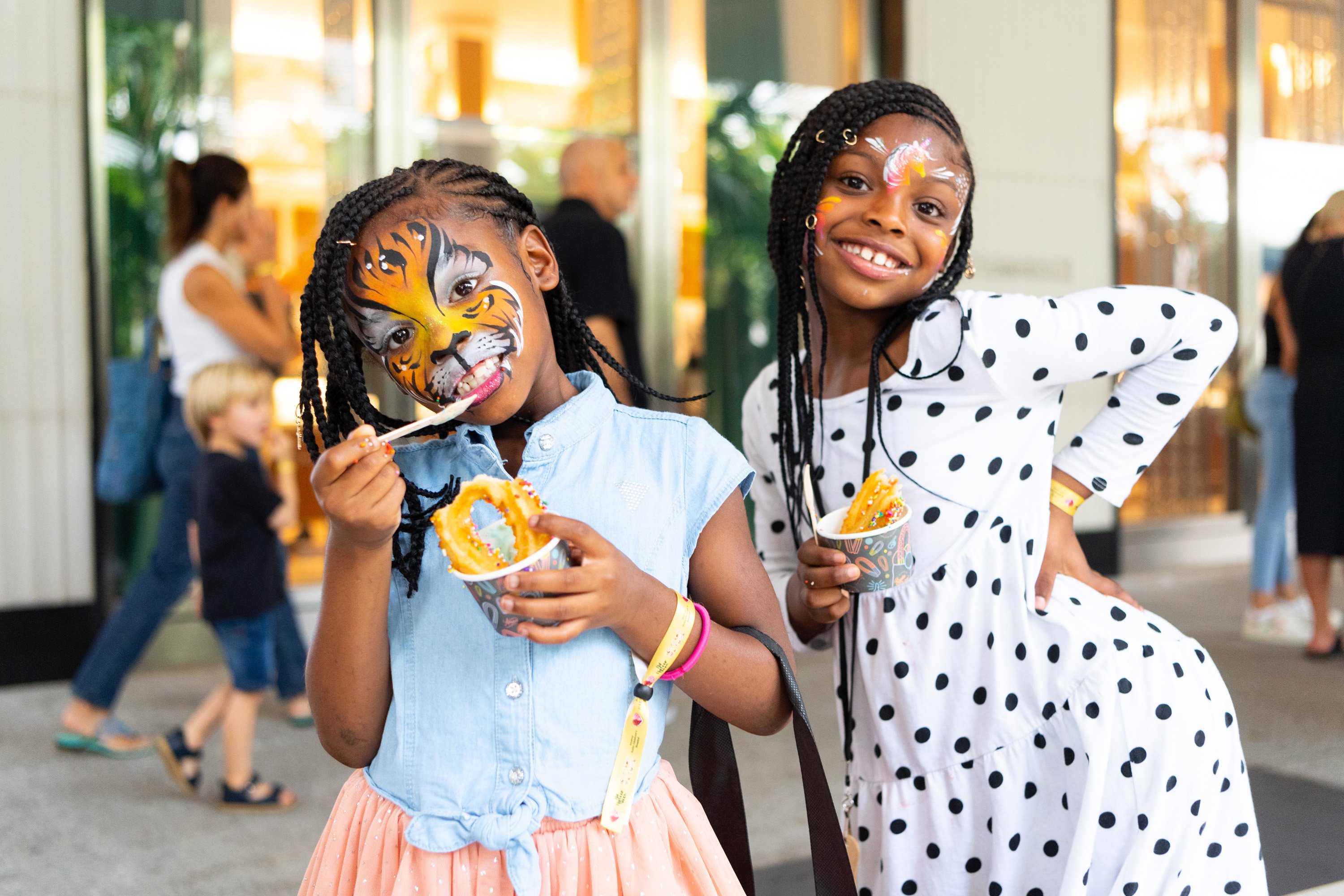 A variety of images showcasing the fourth annual “Ice Cream We Love” event. Images include guests in attendance, ice cream treats and setup, and activities featured at the event including games, face painting, and performances.