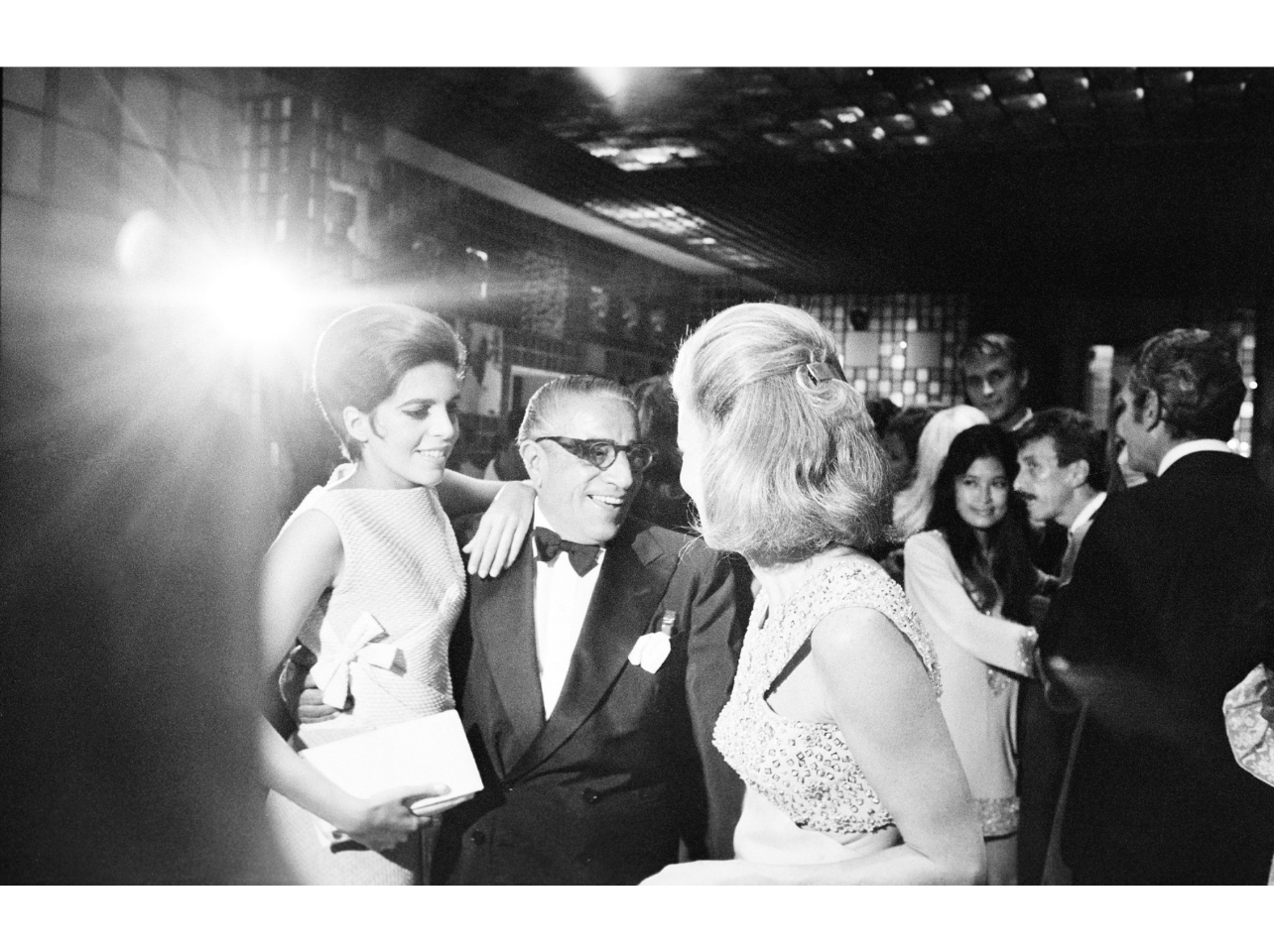 Black and white portrait of Aristotle Onassis with daughter Cristina at Marina Cicogna’s party, Venice 1967