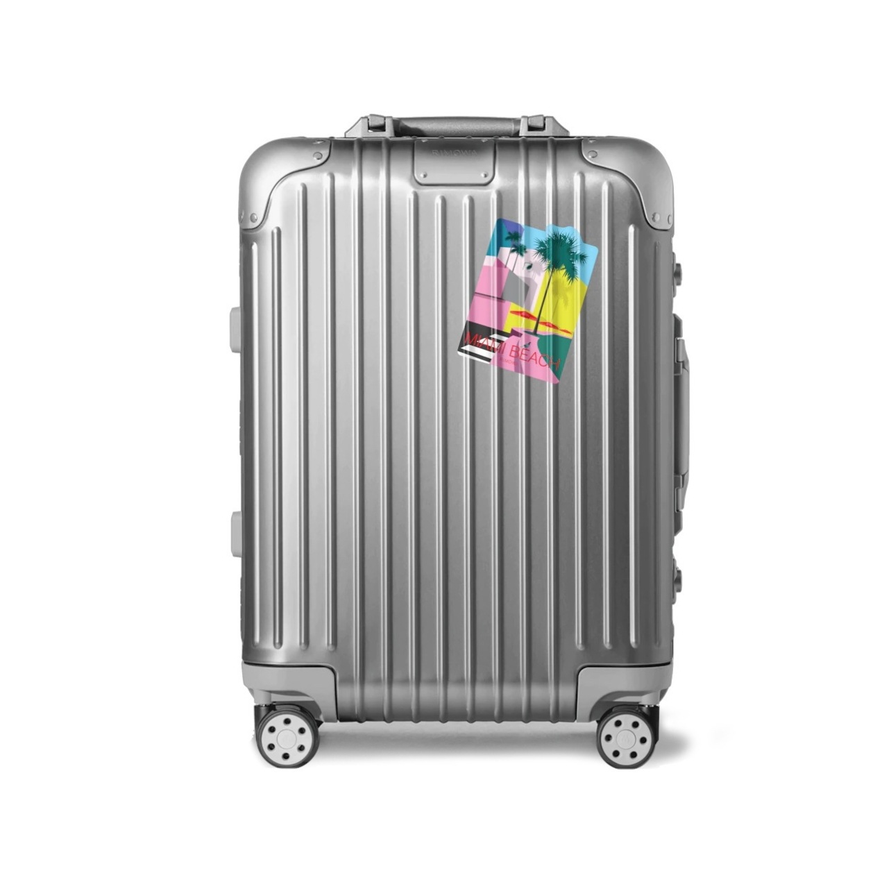 Silver Rimowa luggage with stickers