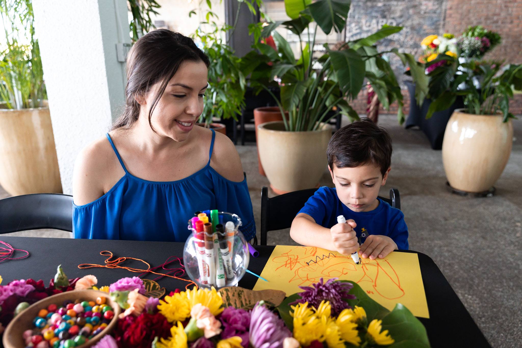 Mother and son creating art during the class