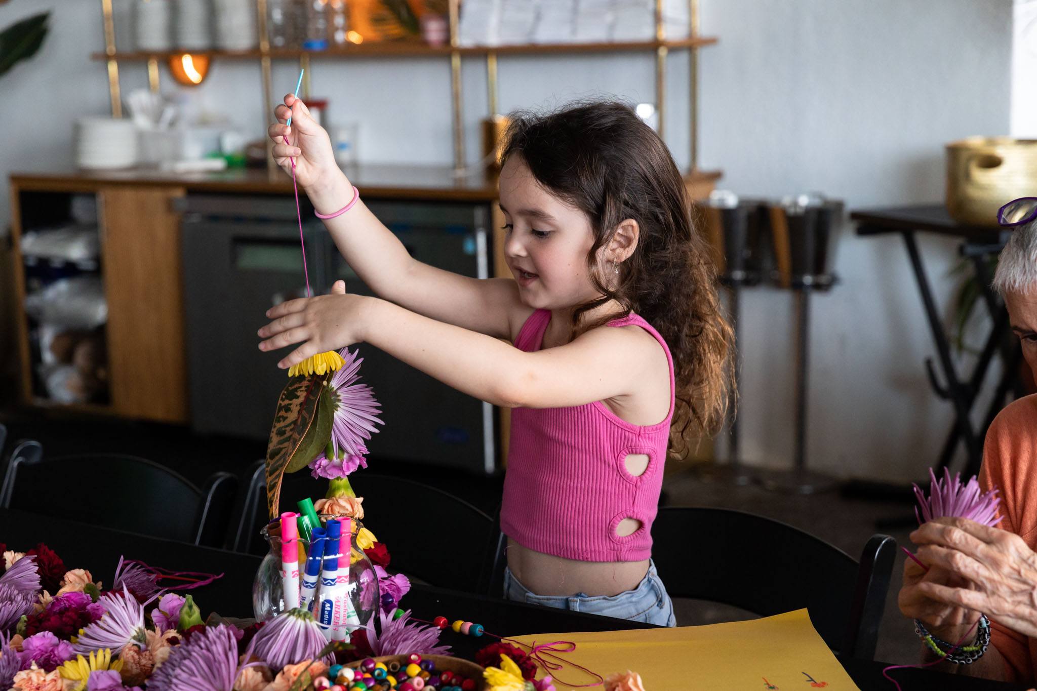 Child creating a floral lay