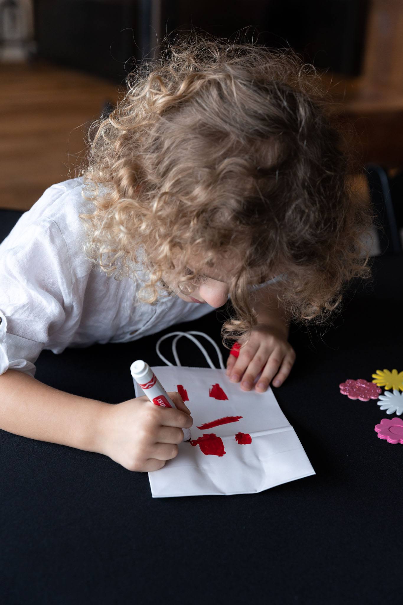 Children in attendance customized gift bags to bring home their art