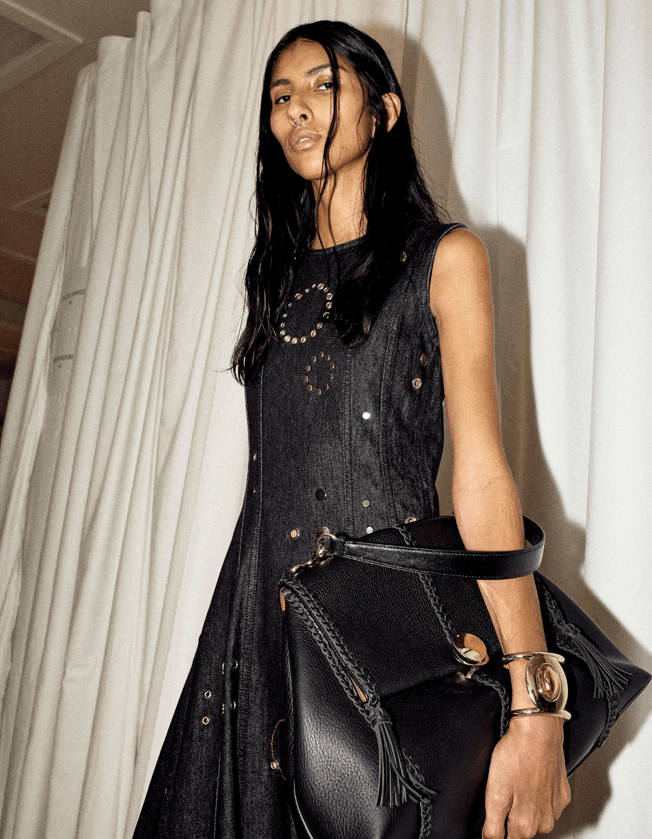 A model in a black Chloe dress and black Penelope bag, backstage at the Spring/Summer show