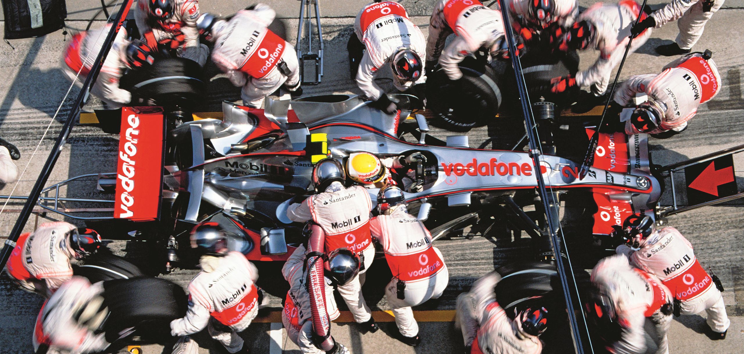 Portrait capturing a pit stop during the 2007 Malaysian Grand Prix. Photography by Darren Heath
