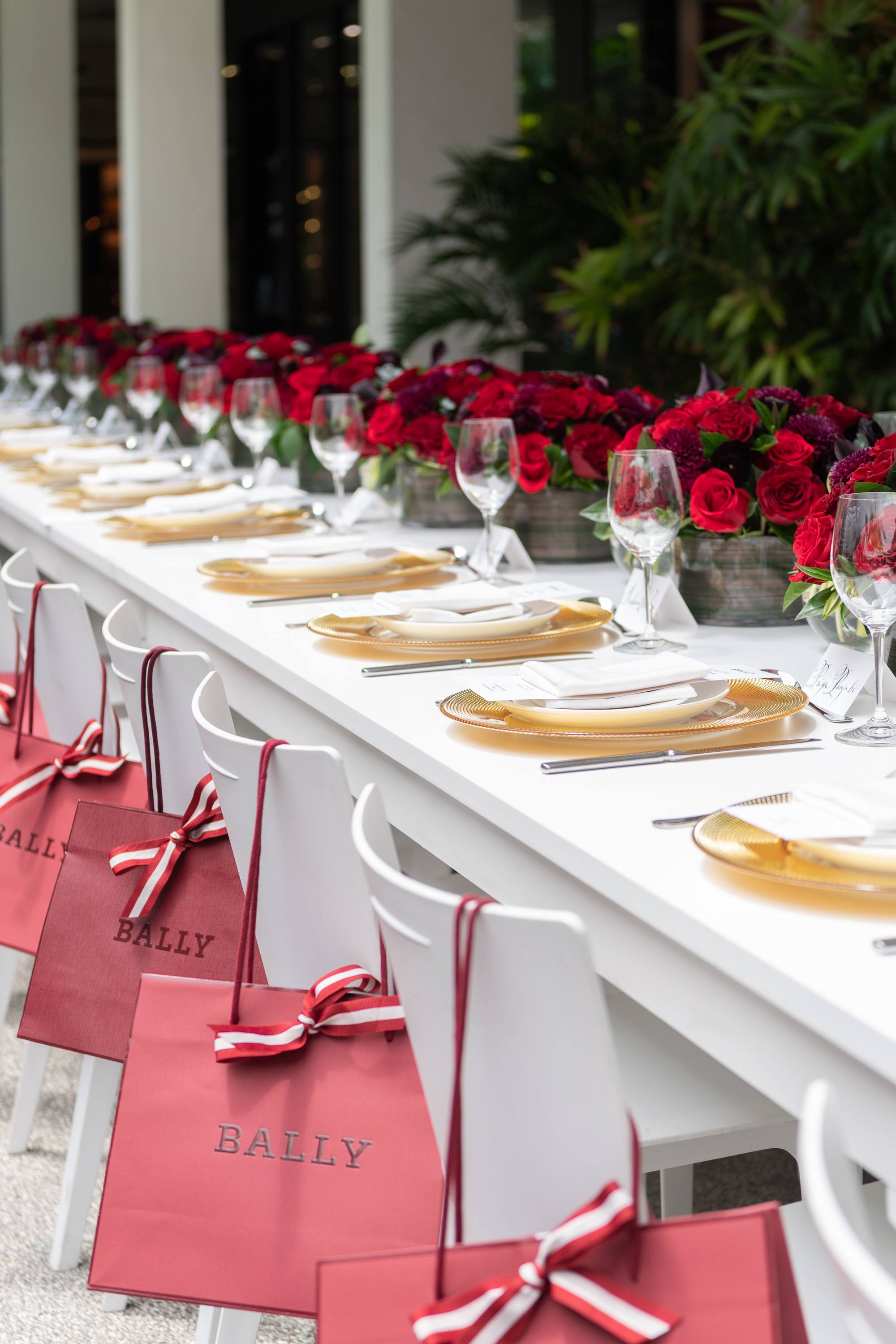 Bally luncheon table adorned with roses and Bally gift bags