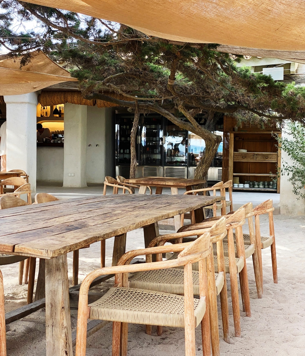 Outdoor wooden table with chairs outside of Casa Jondal beachfront dining