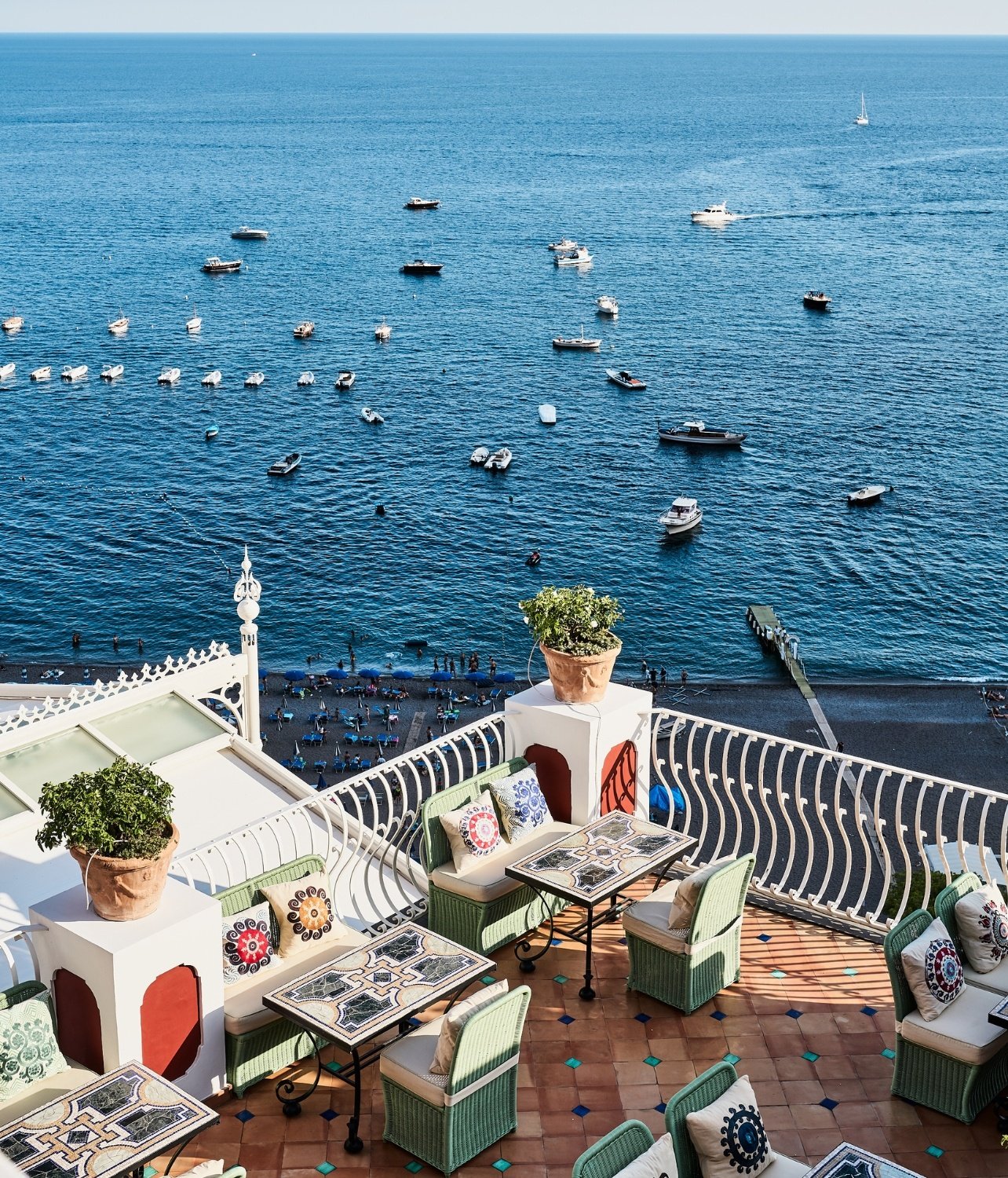 View of boats in Positano from the restaurant balcony at the Sirenuse hotel