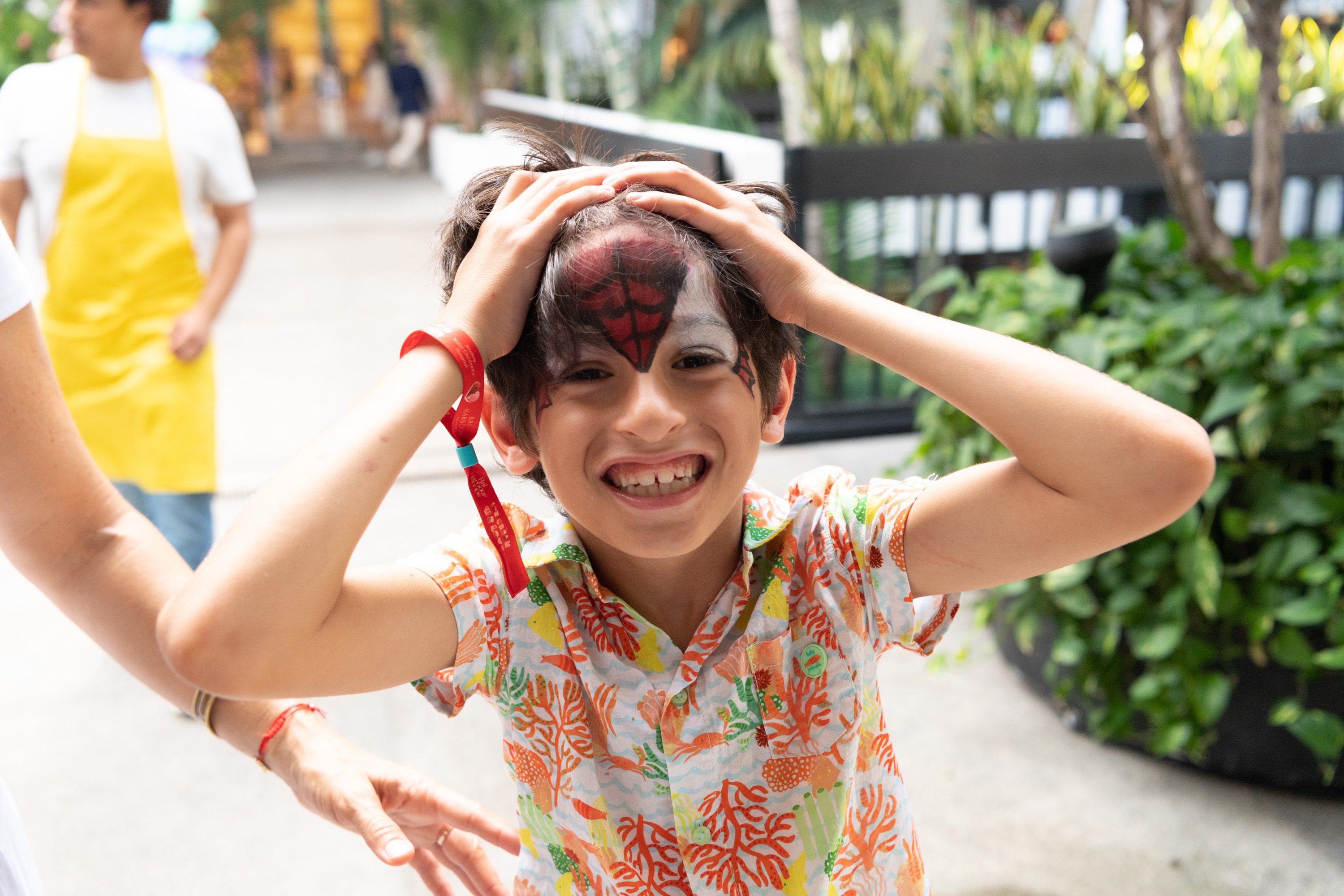 Child showing off custom Spiderman face paint