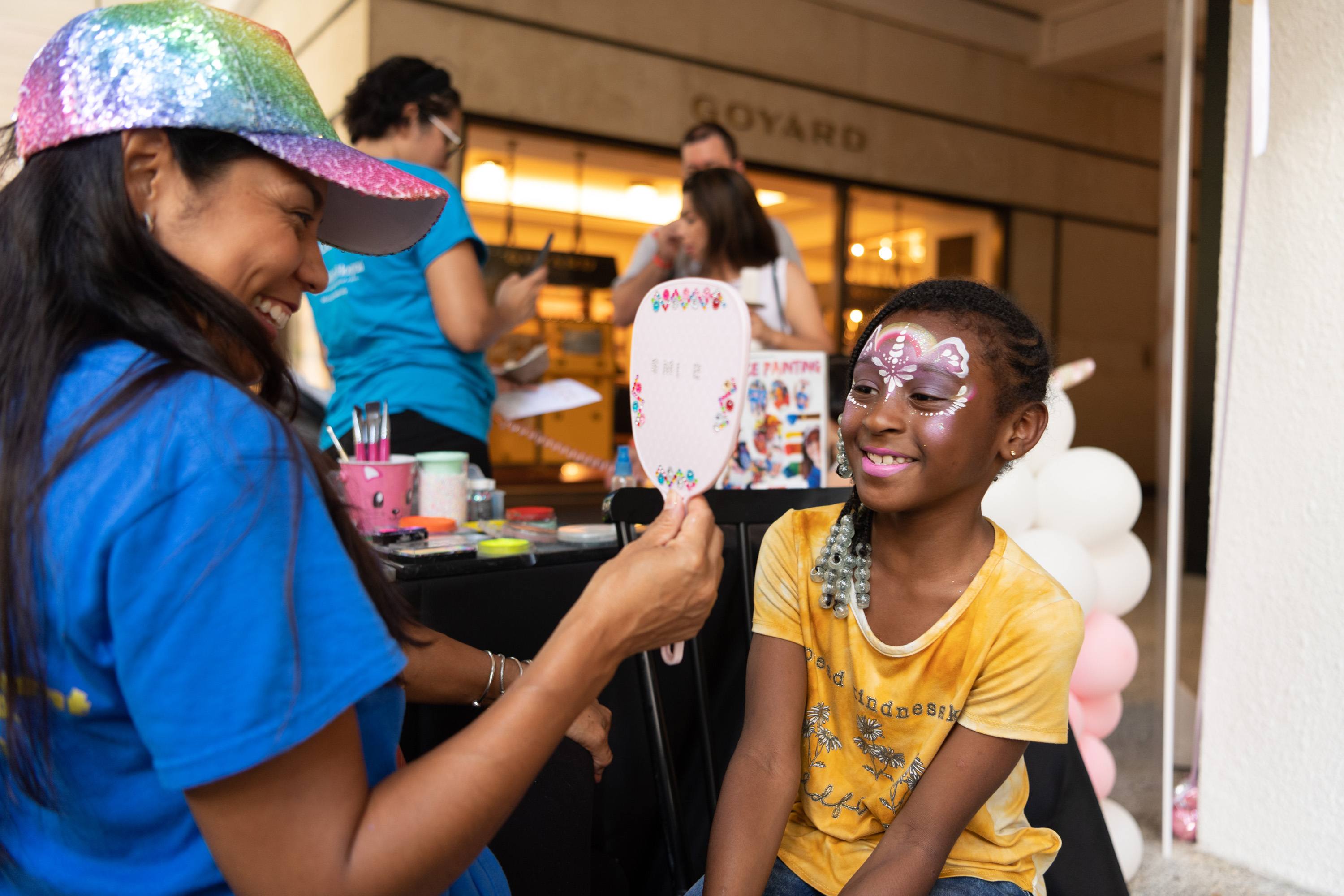 Children attending Ice Cream We Love weekend enjoy decorative face painting