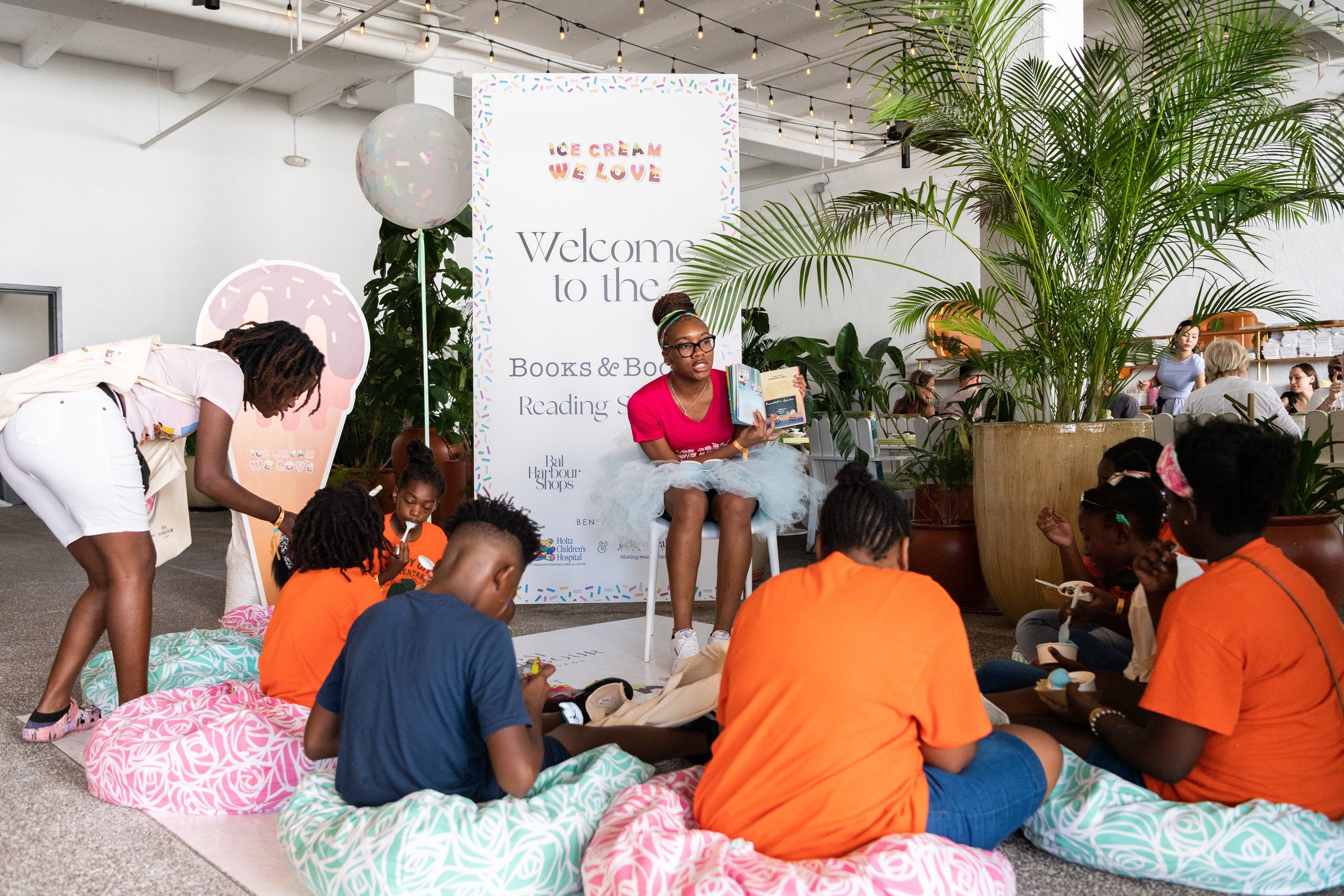 Arrianna Robinson reading to the kids at the reading station