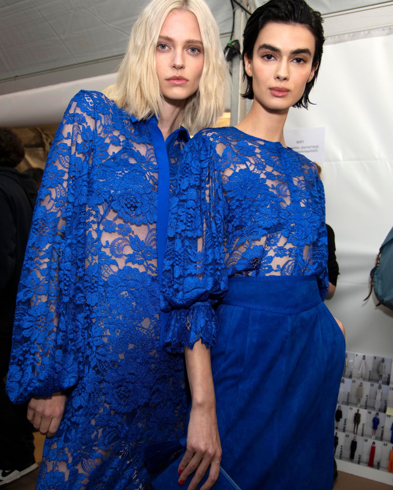 Models wearing blue lace Akris looks backstage at the Spring/Summer 2023 fashion show
