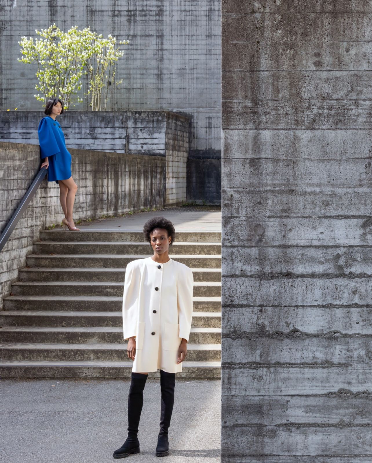 Models wearing archival Akris looks from the 1980’s standing in front of the University of St. Gallen