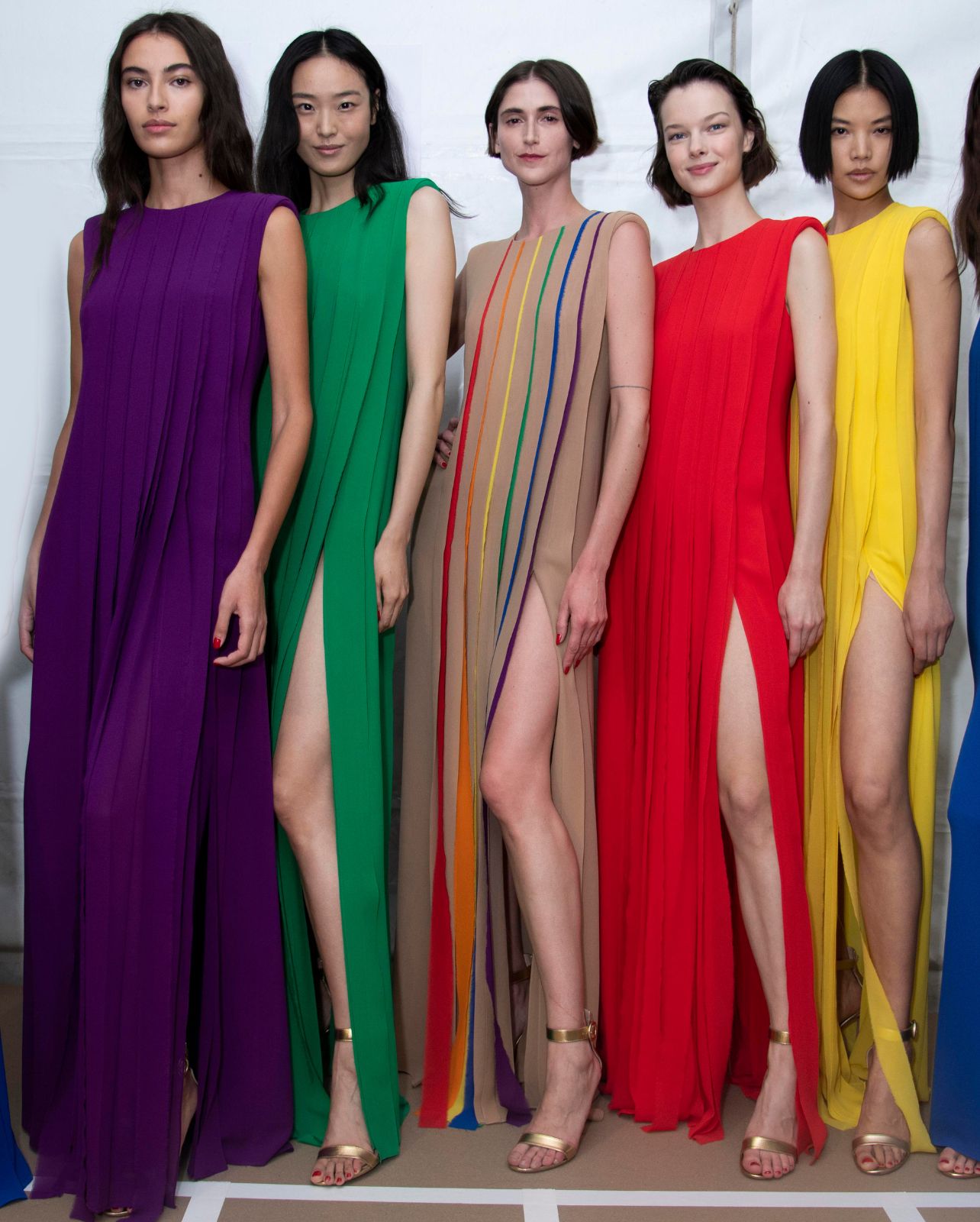 Models wearing a rainbow of Akris maxi dresses at the Spring/Summer 2023 runway show