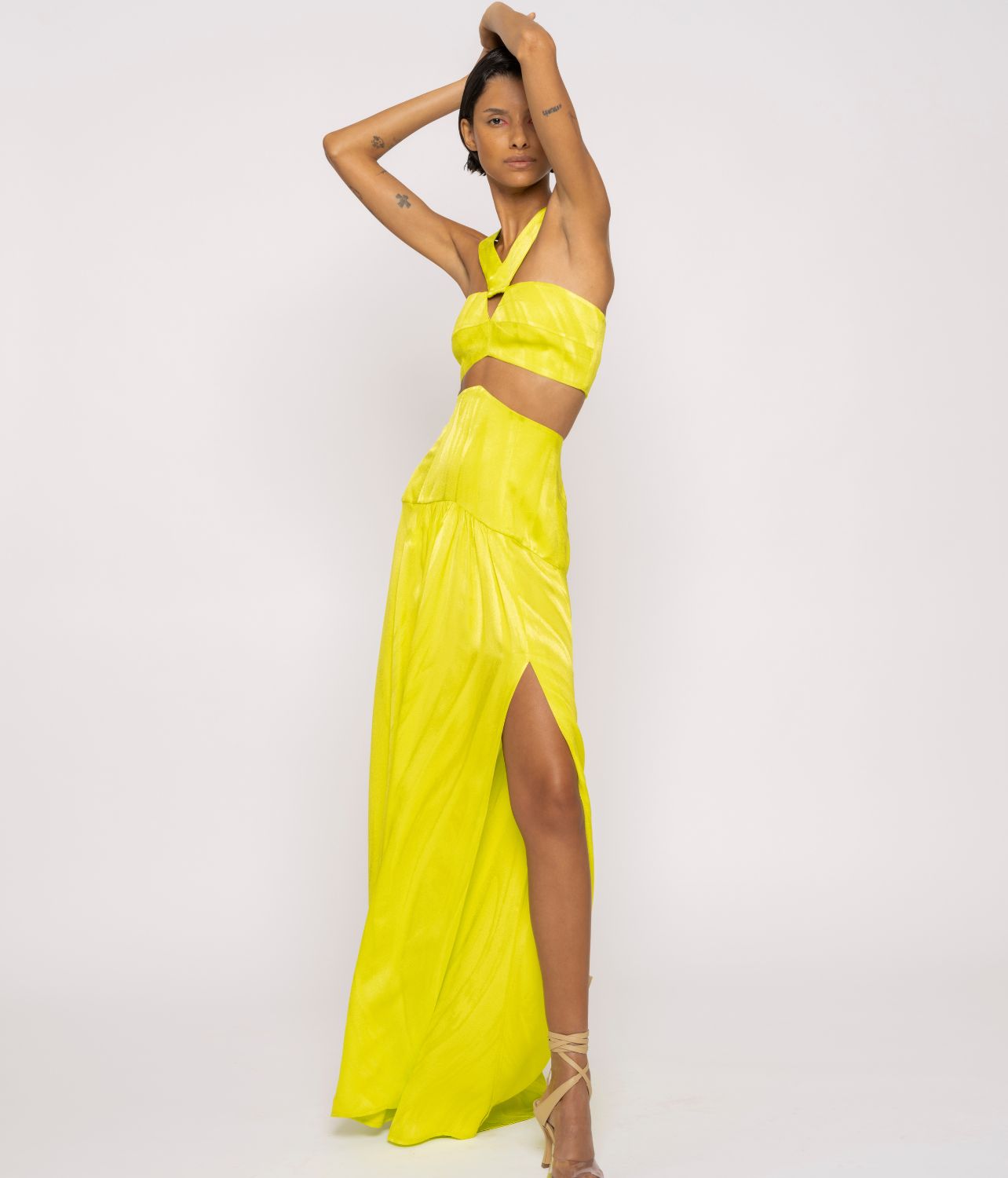 Model wearing yellow Silvia Tcherassi maxi skirt and halter top from their Spring/Summer collection